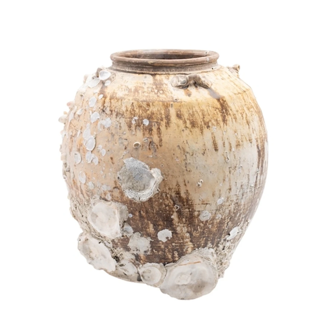 Diana Cargo a Chinese oviform storage jar under brown glazes...