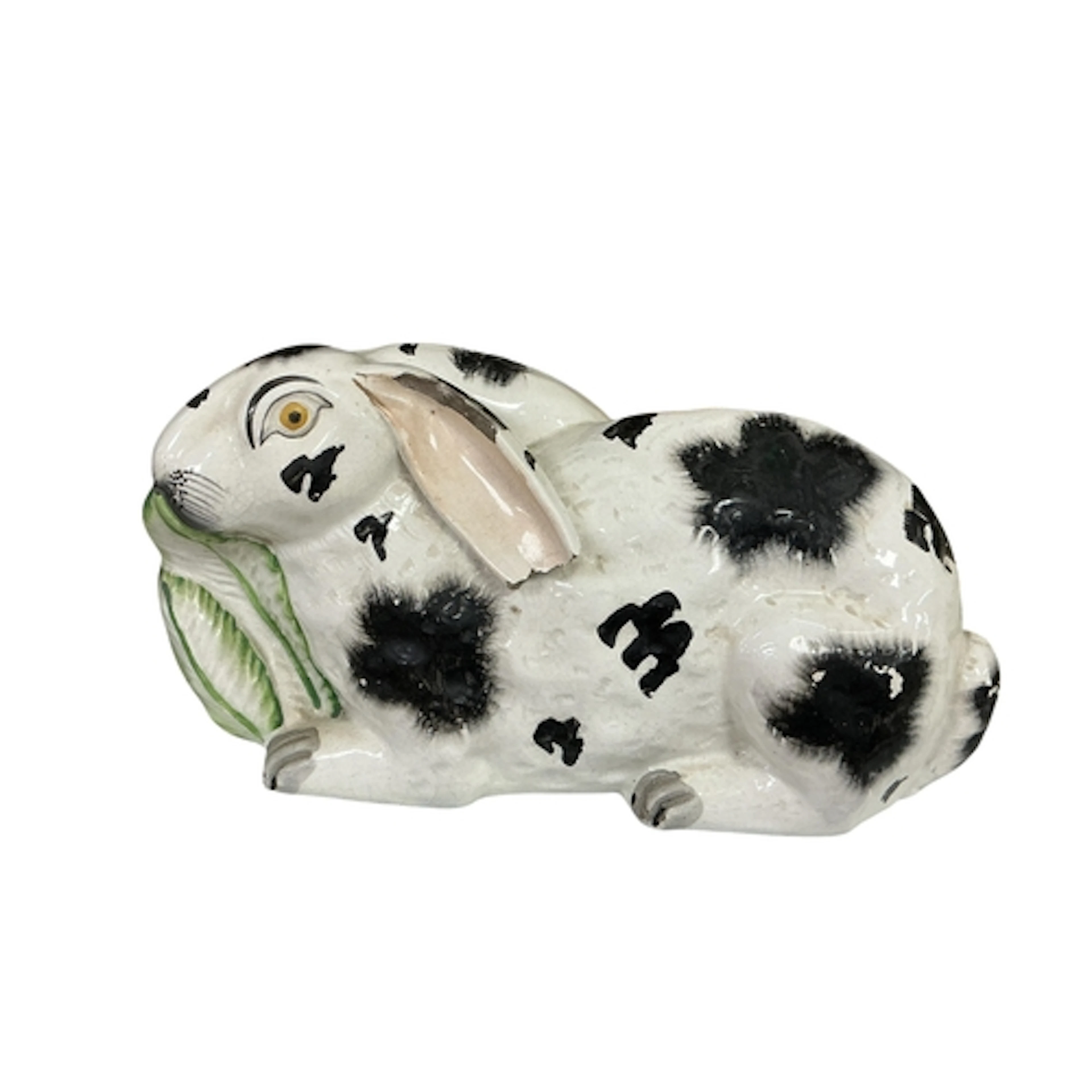 A 19th century Staffordshire spongeware pottery recumbent ra...