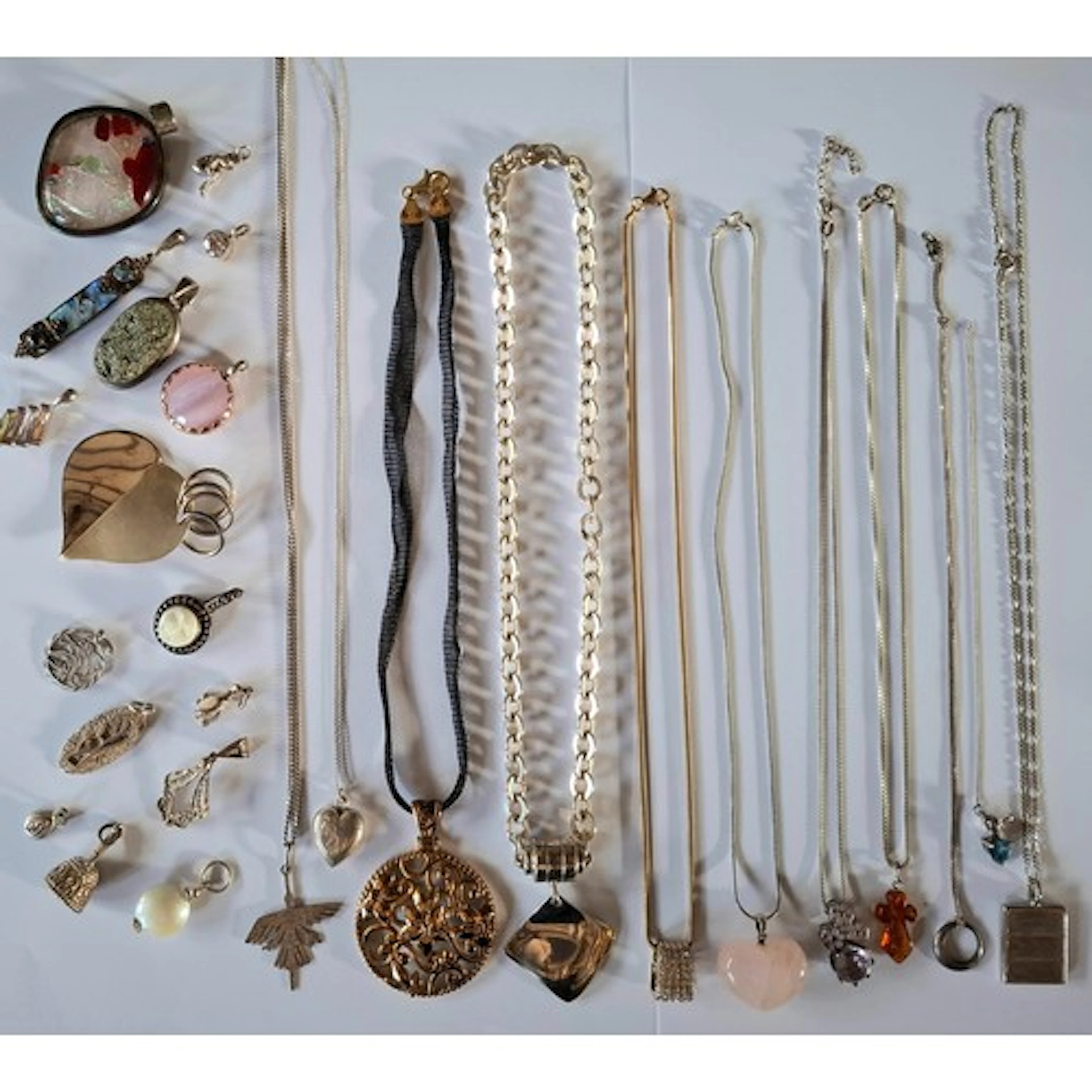 Silver chains with mixed pendants and charms to include an E...