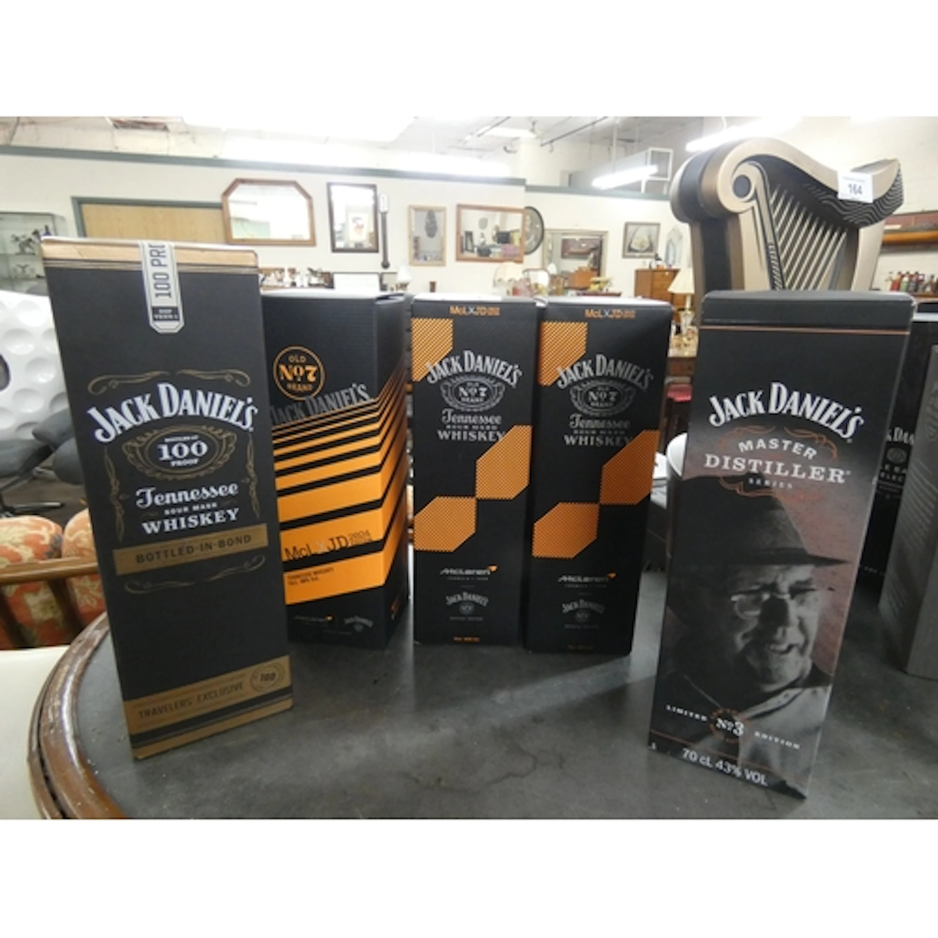 Three bottles of Jack Daniels McClaren number 7 whiskey, a b...