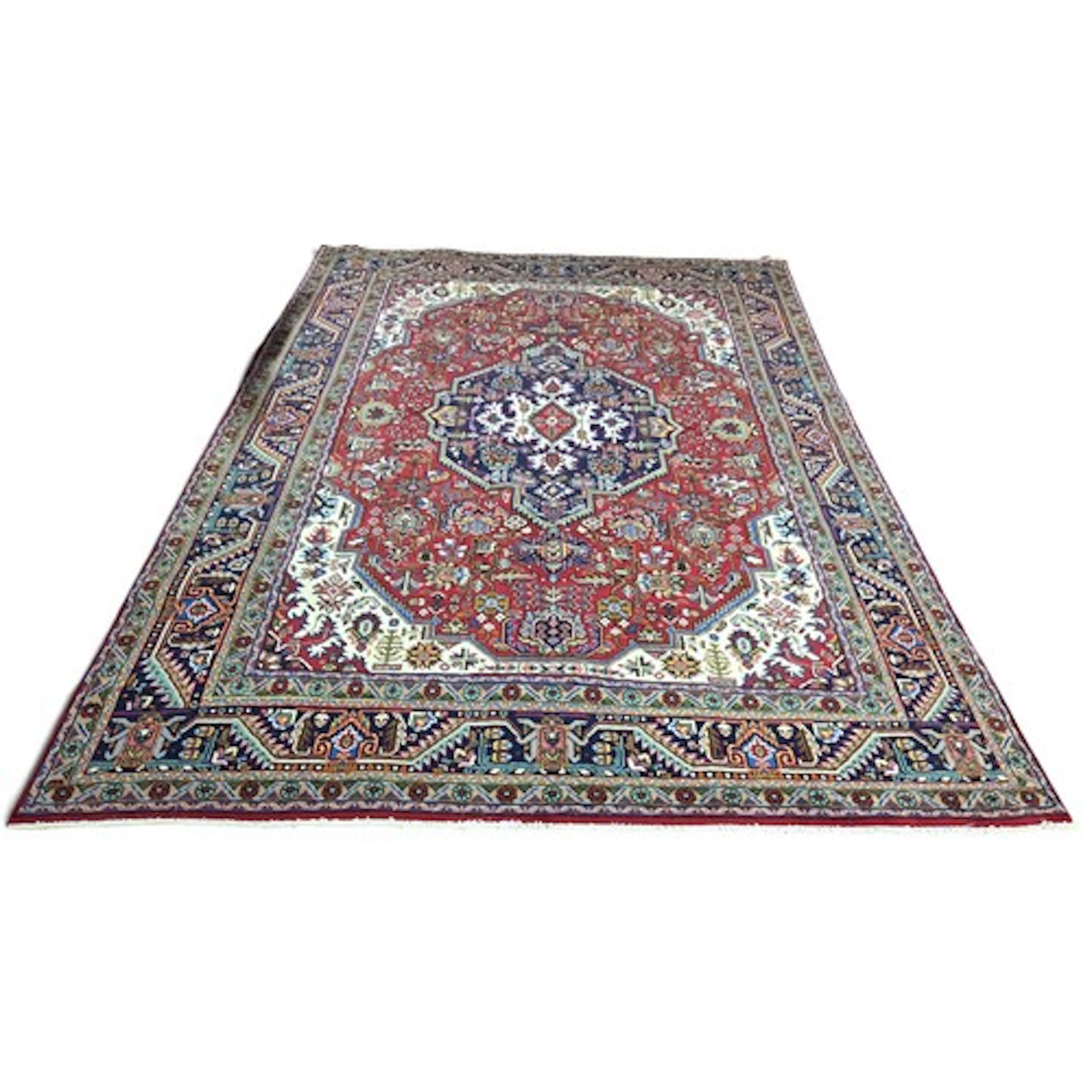 A fine hand-woven Persian Tabriz carpet, with a full wool pi...