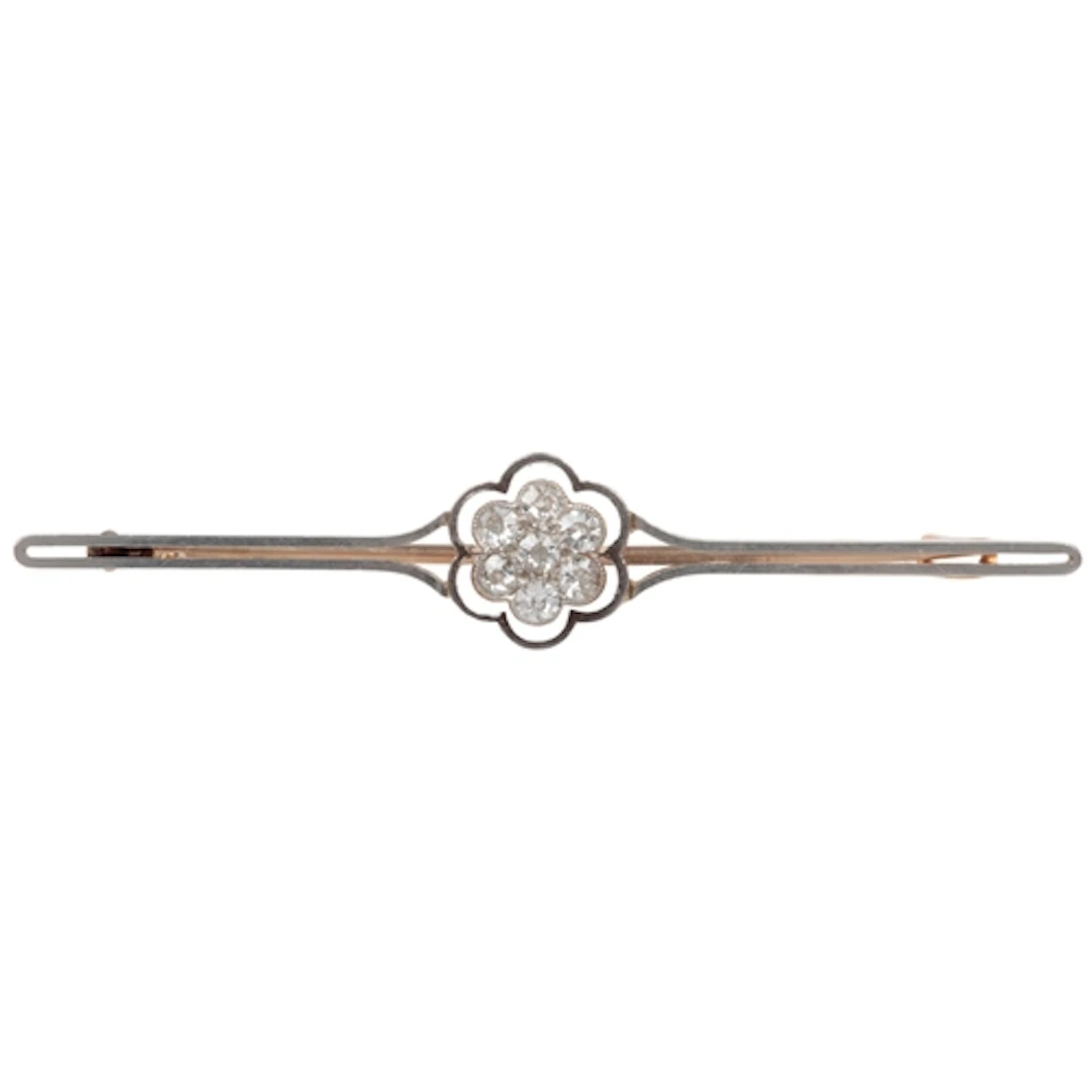 A diamond bar brooch, early 20th century, centring on a clus...