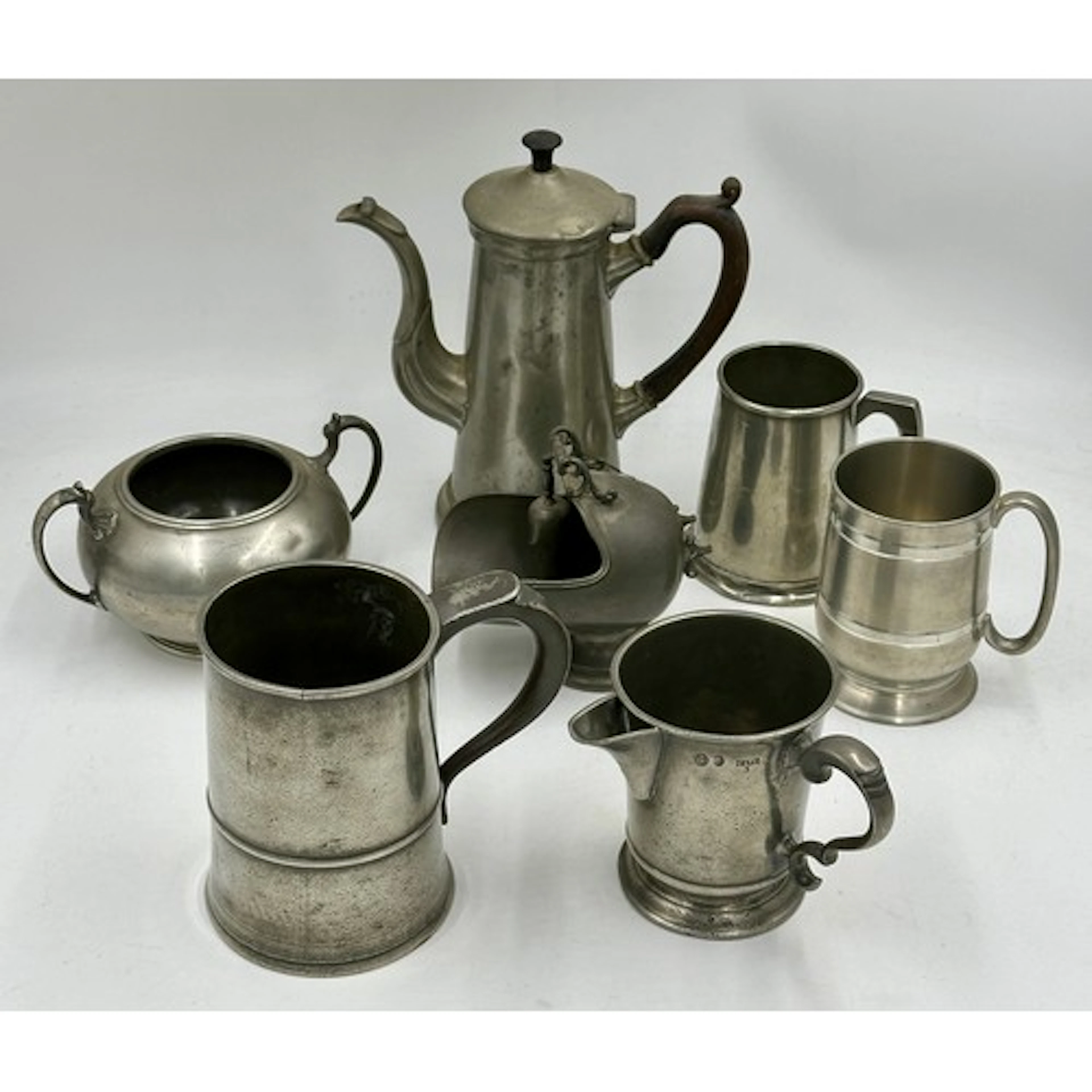 A collection of 19thC pewter to include a quart tankard stam...