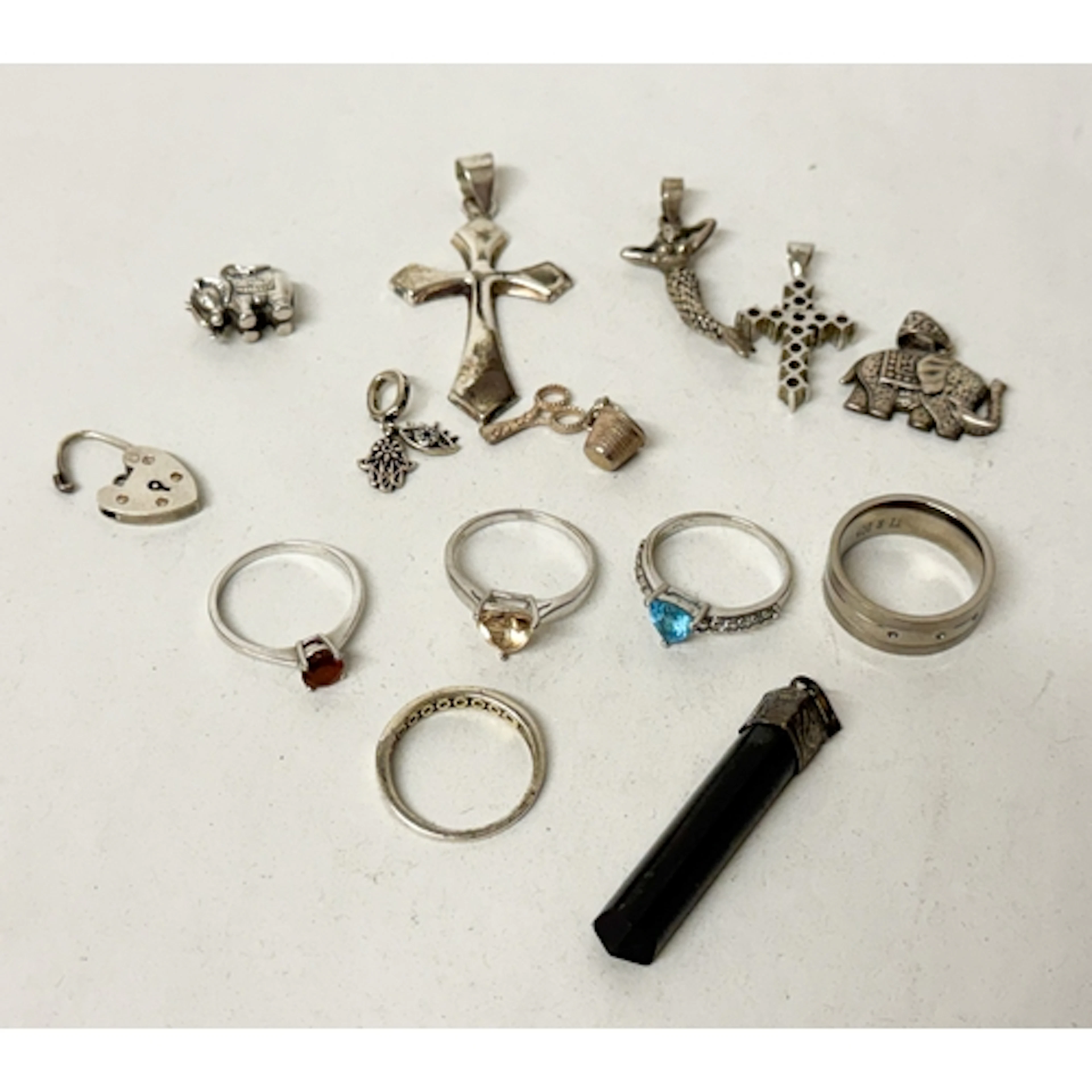 A collection of silver rings and pendants and a modern Titan...