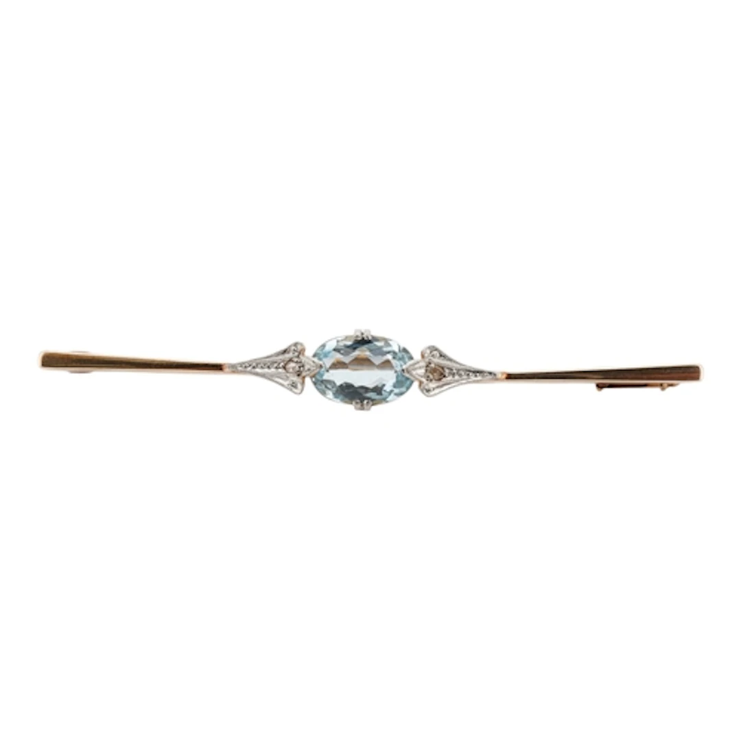 An aquamarine and diamond bar brooch, set with an oval aquam...