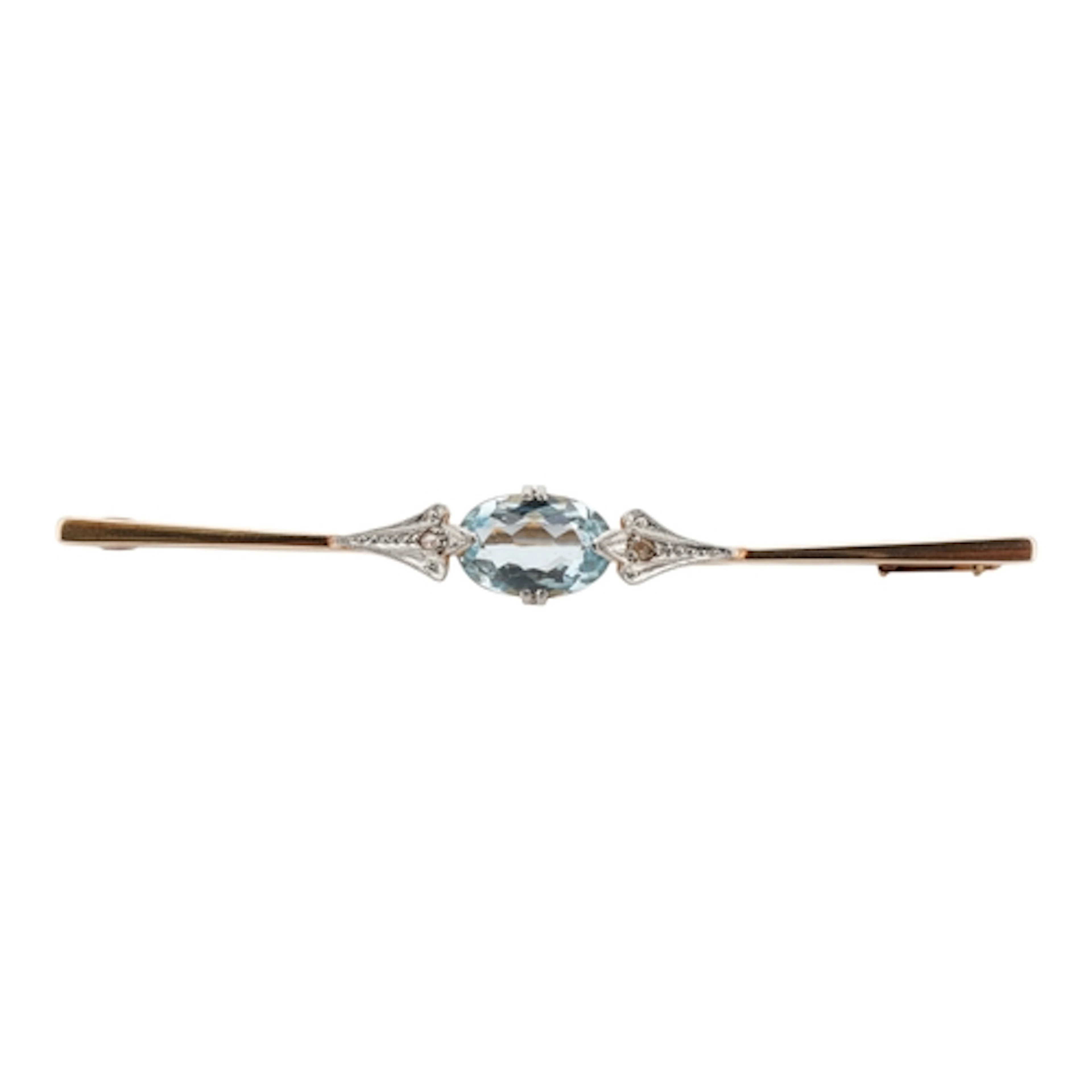 An aquamarine and diamond bar brooch, set with an oval aquam...