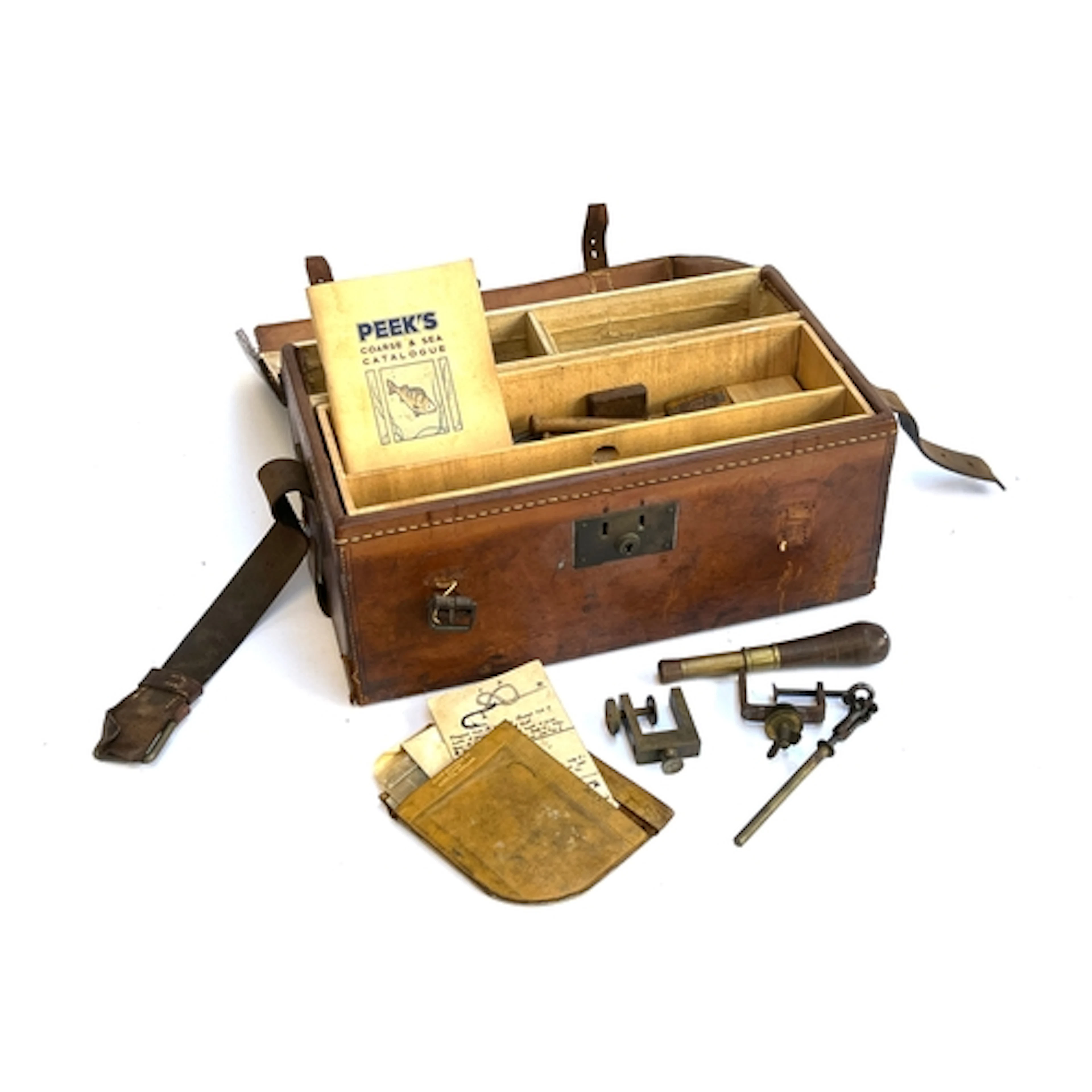 A leather case containing various fly tying equipment, to in...