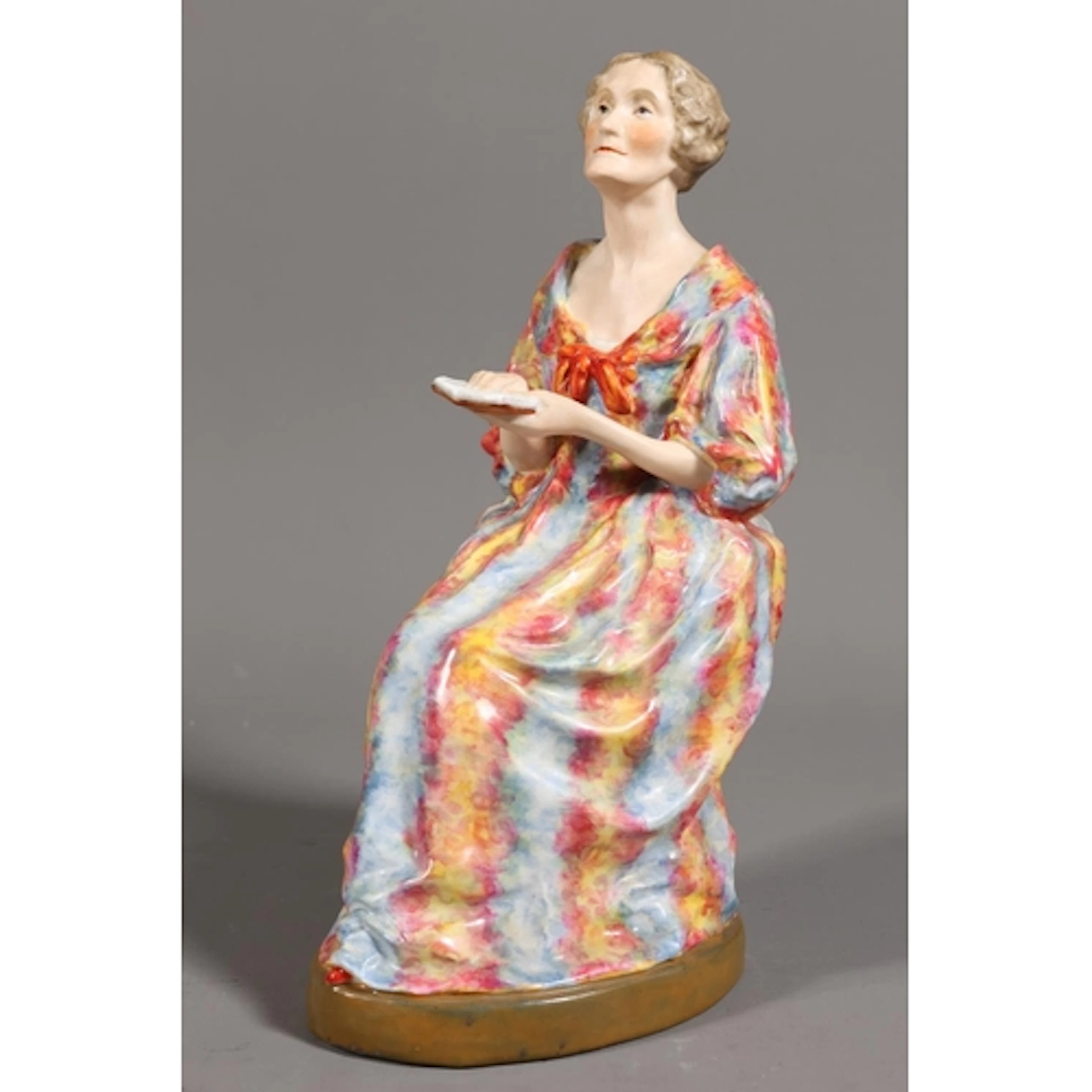 Royal Crown Derby figure of an elderly lady reading a book.