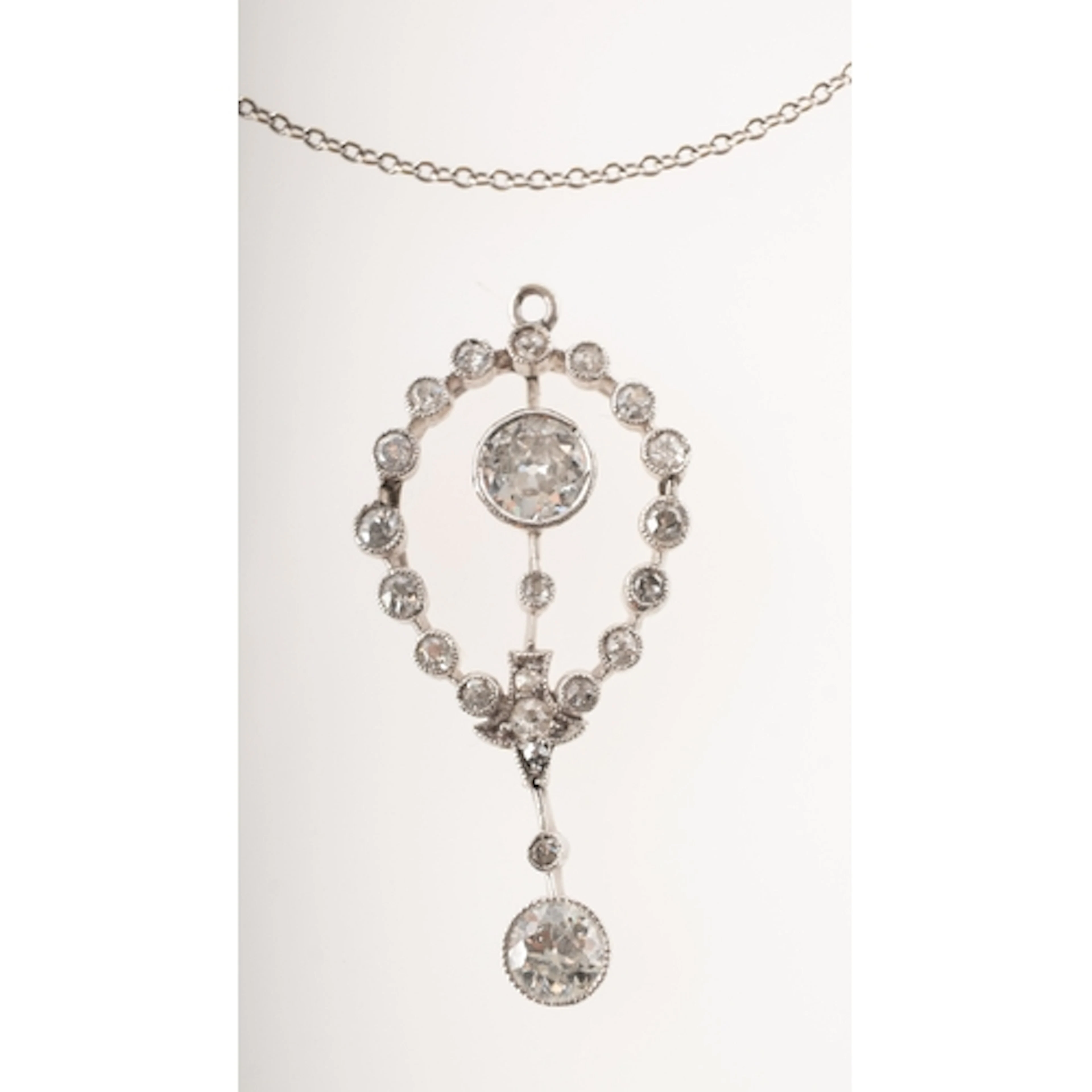 A Belle Epoque diamond pendant with chain, of openwork oval ...