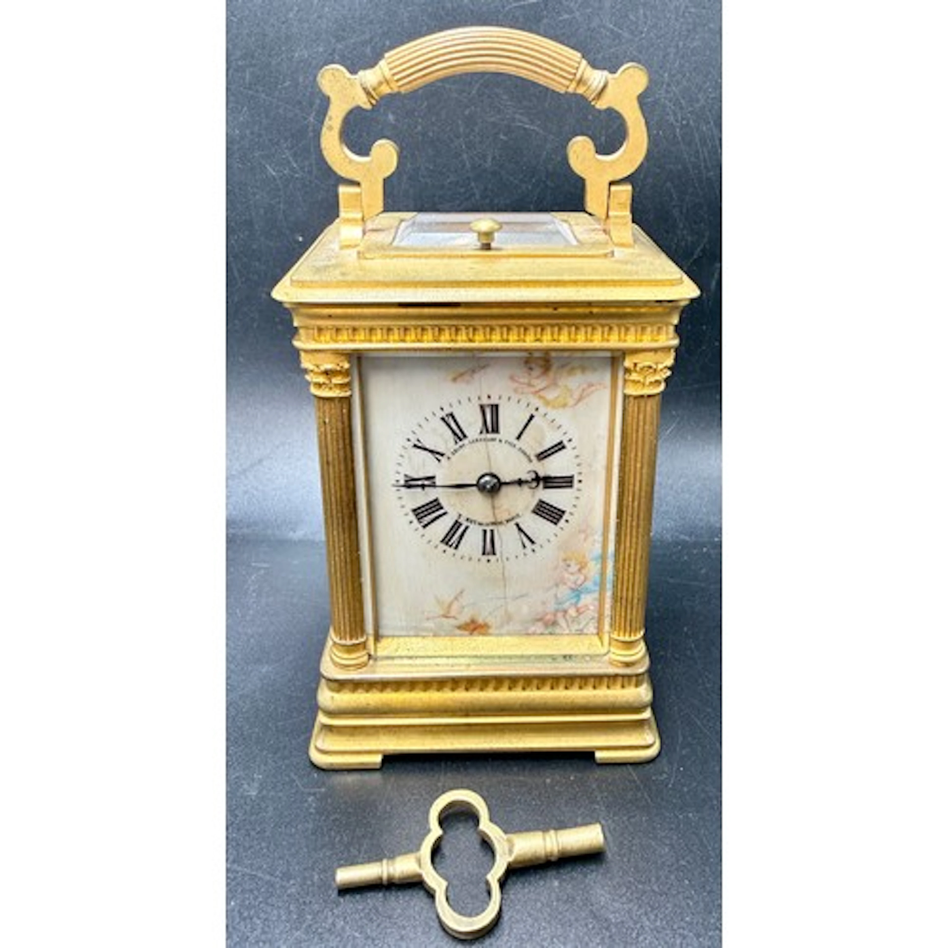 A brass cased carriage clock with Corinthian column corners ...