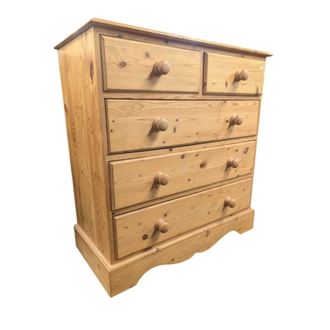 A modern solid pine chest of drawers. The chest having a two...