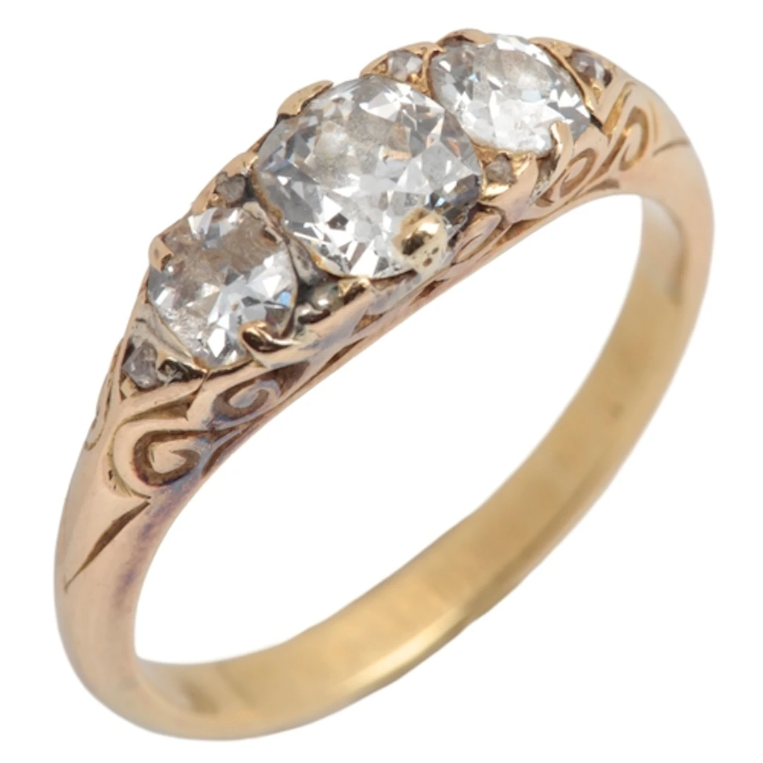 A three-stone diamond ring, late 19th century, centring on a...