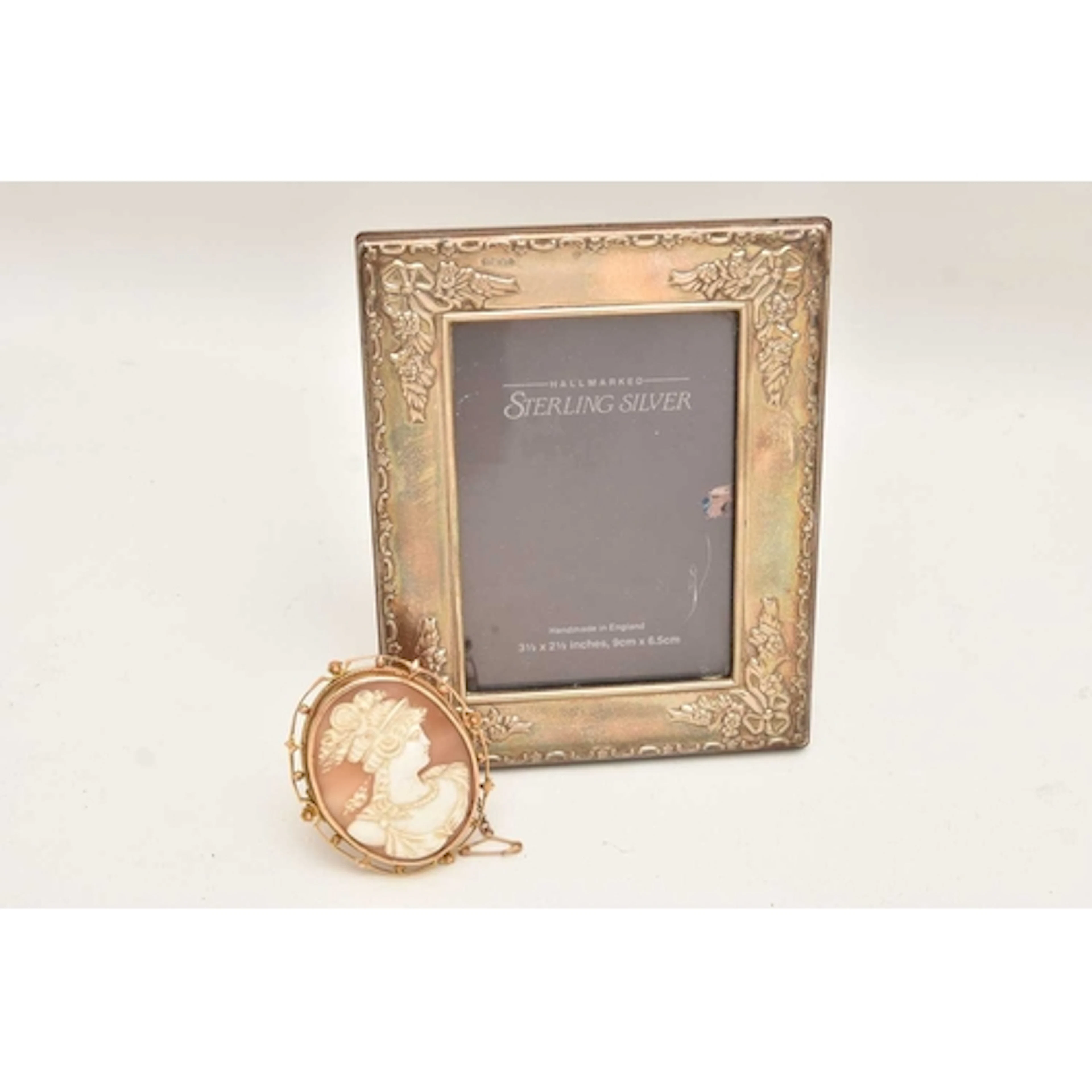 A CAMEO BROOCH PENDANT AND SILVER PICTURE FRAME, an oval for...