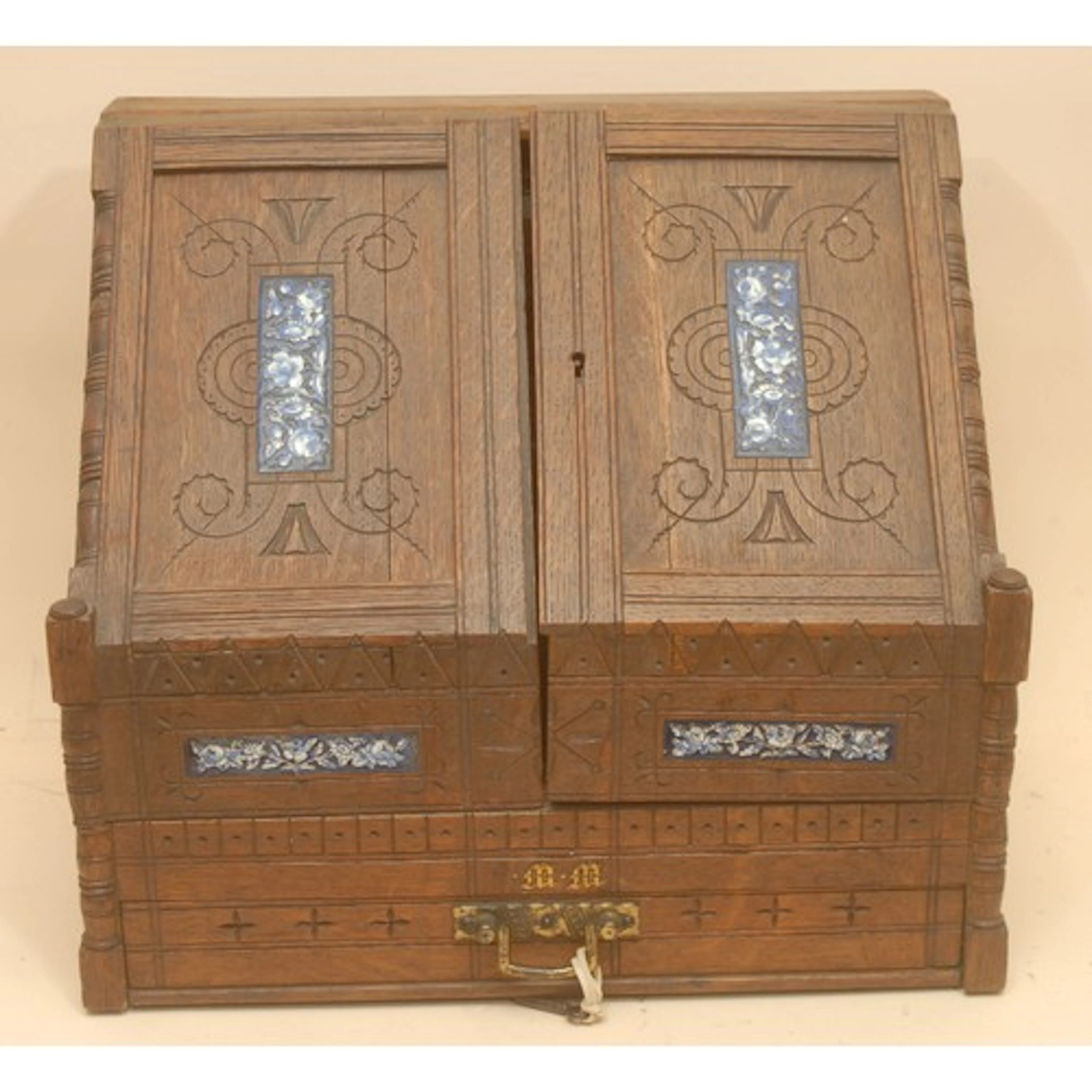 A Victorian Aesthetic Movement enamel mounted oak slope fron...