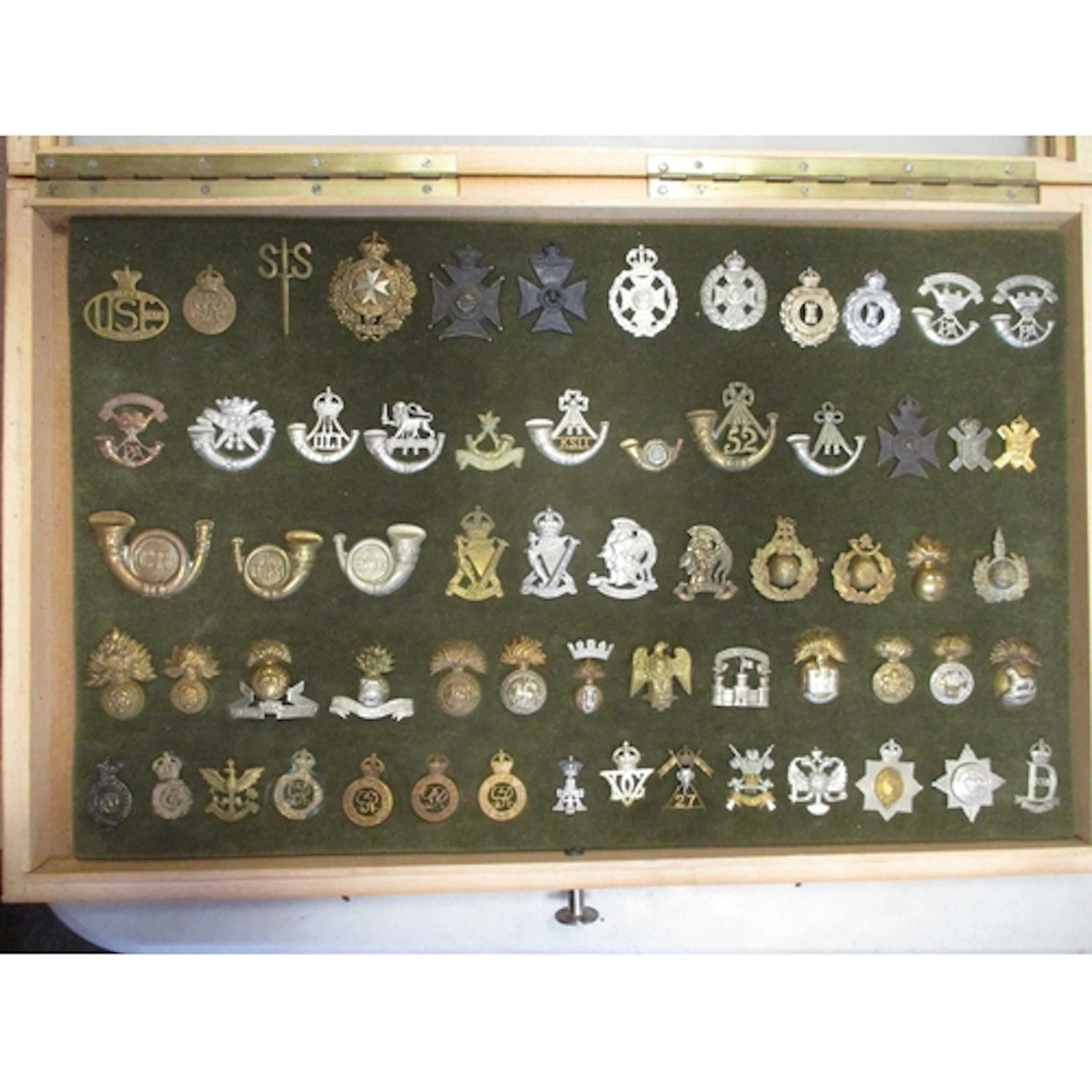Cap badge collection mounted on foam in home made glass disp...