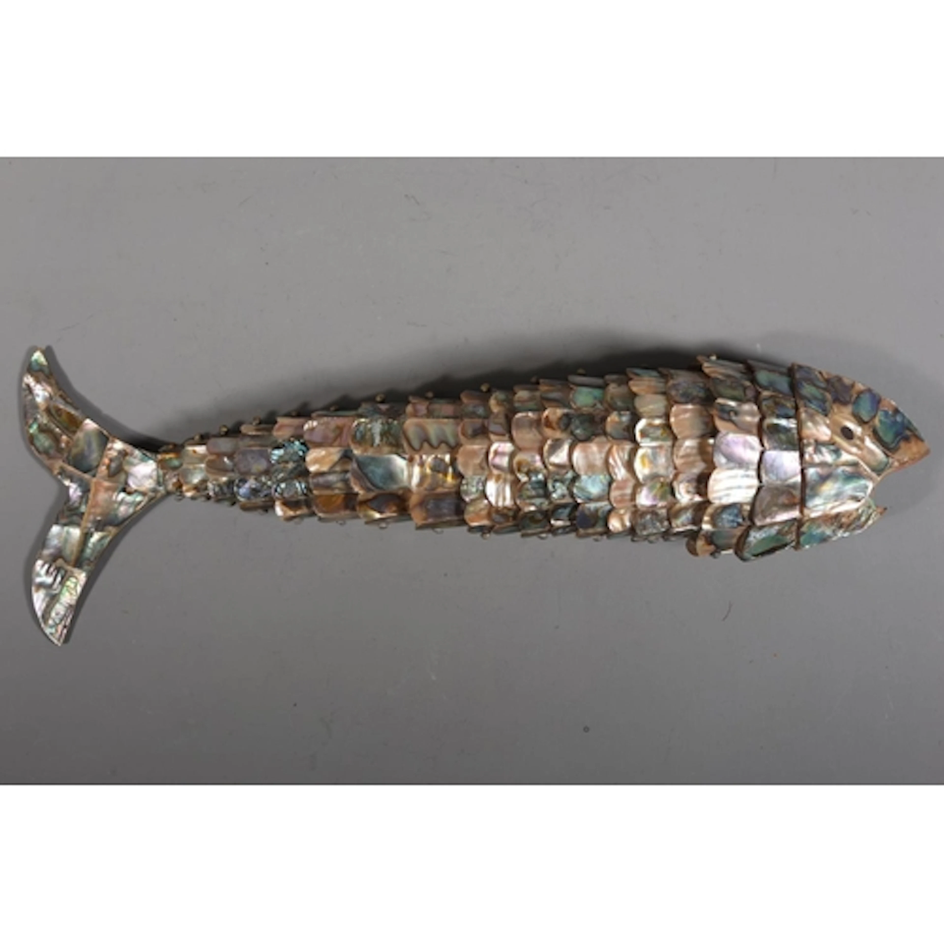 Large bottle opener modelled as a articulated fish set with ...