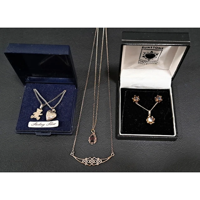 SELECTION OF SILVER AND SILVER MOUNTED PENDANTS ON CHAINS co...