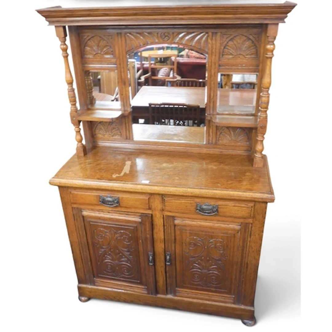 A late Victorian oak mirror backed sideboard with two short ...