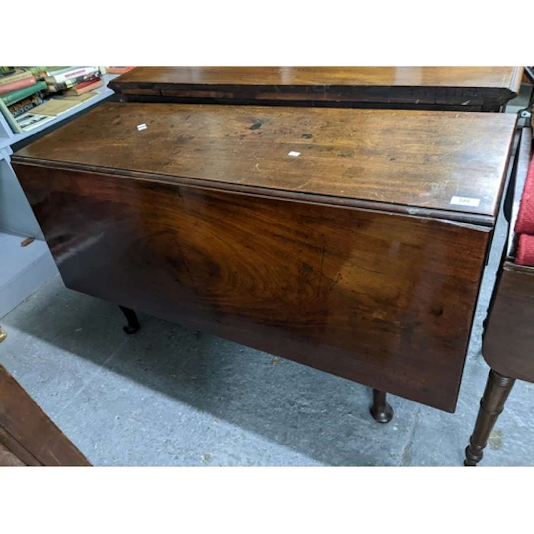 A Georgian mahogany gate leg table, on tapering legs and pad...