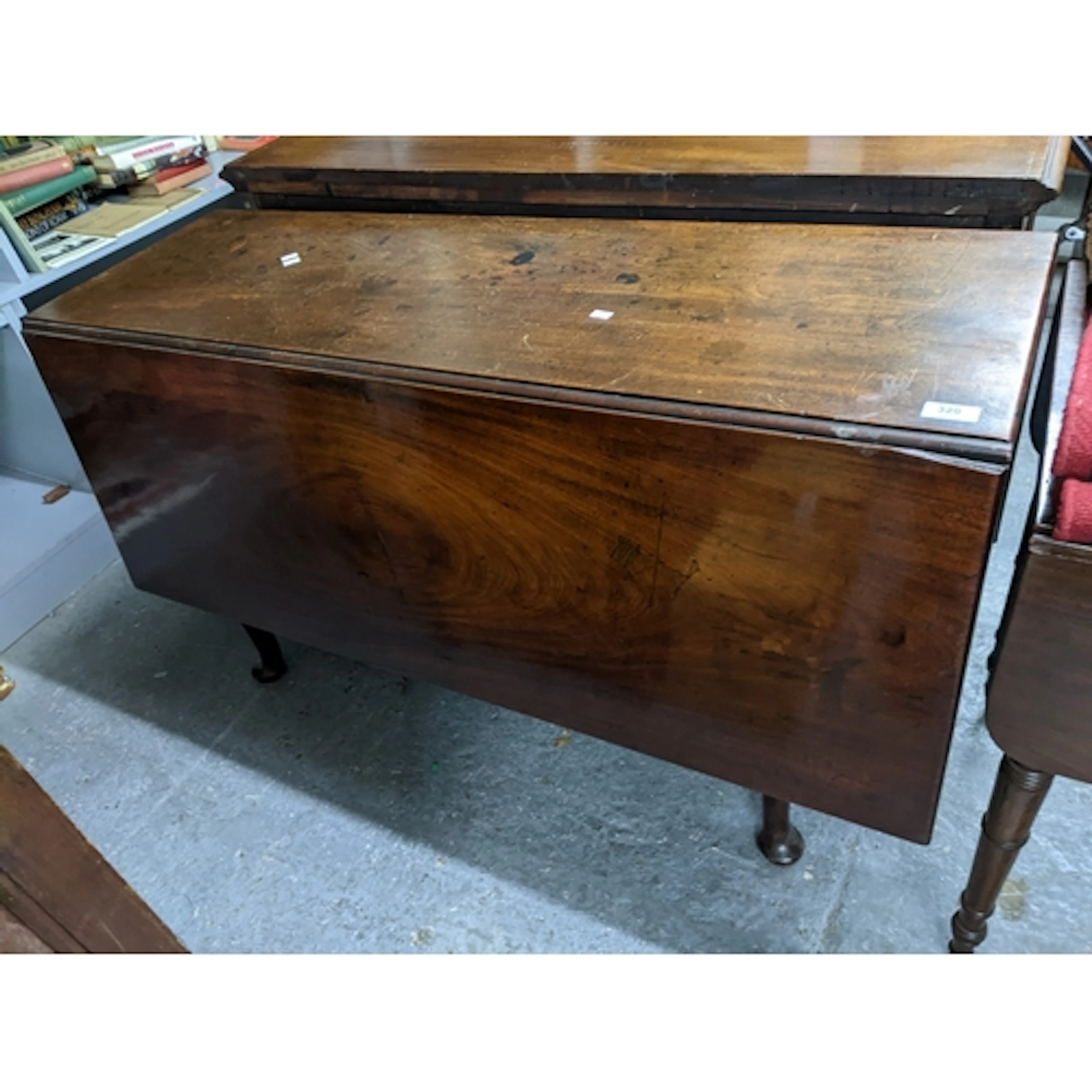 A Georgian mahogany gate leg table, on tapering legs and pad...