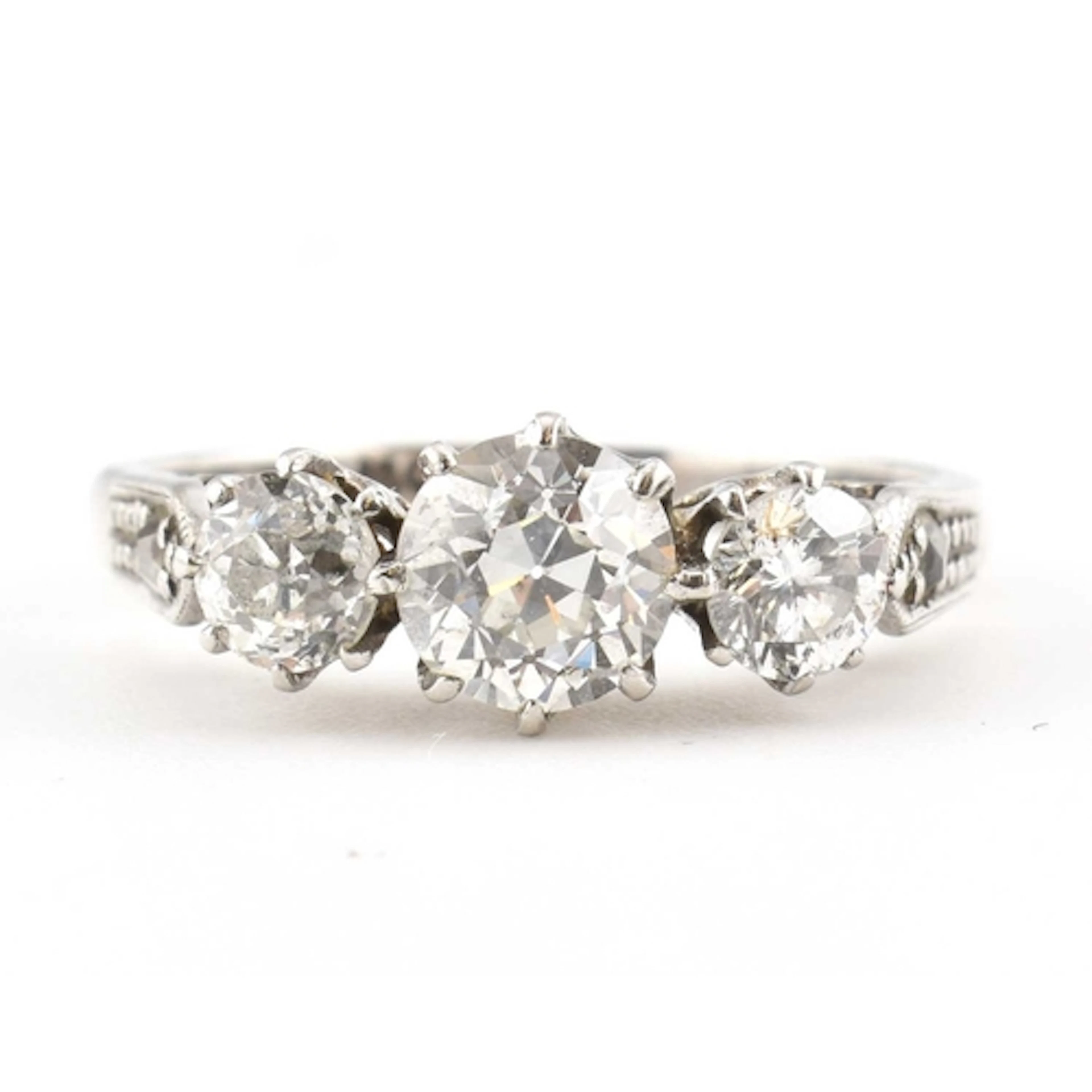 An 18ct gold and platinum diamond ring. Set with three gradu...