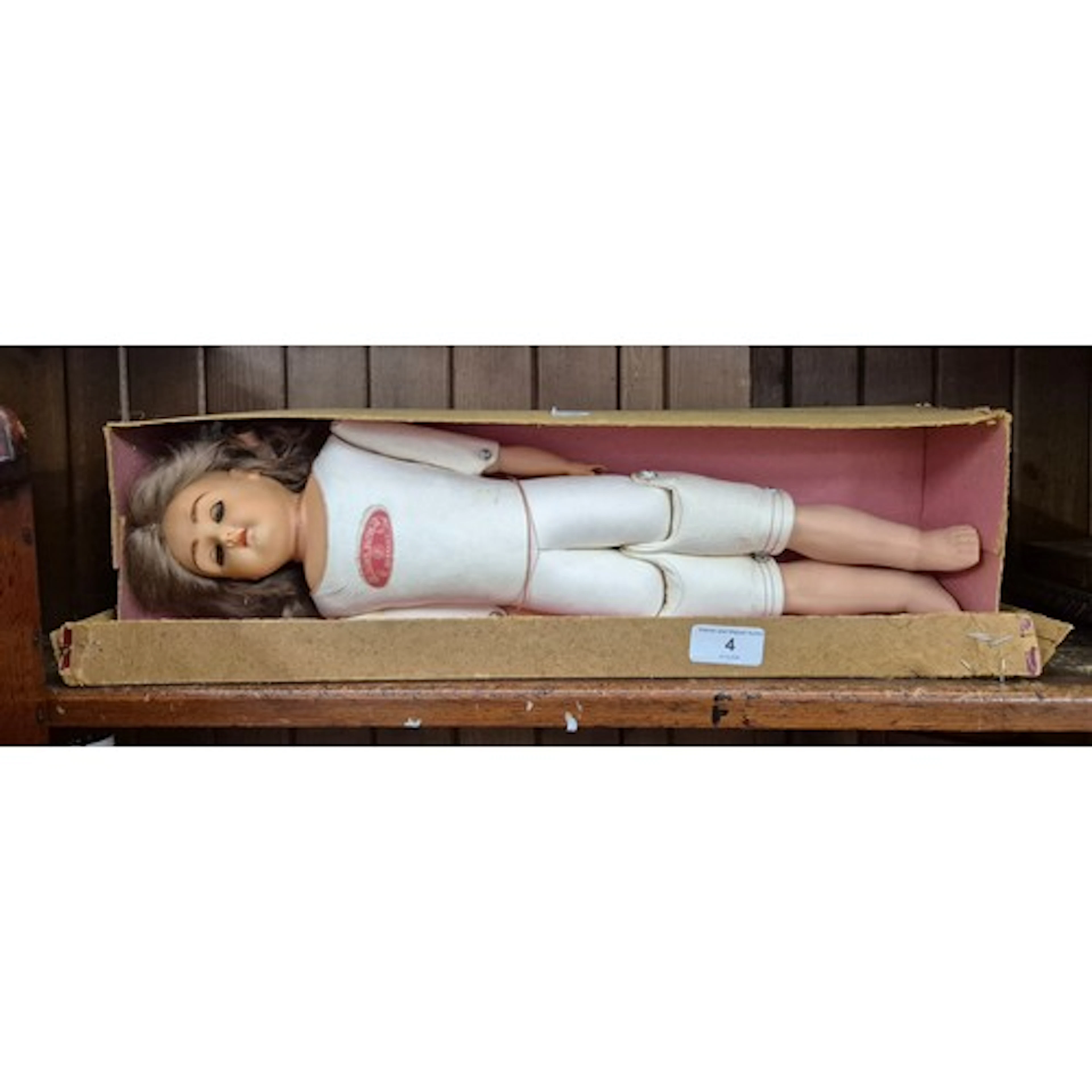 A vintage celluloid headed doll with leather jointed body an...