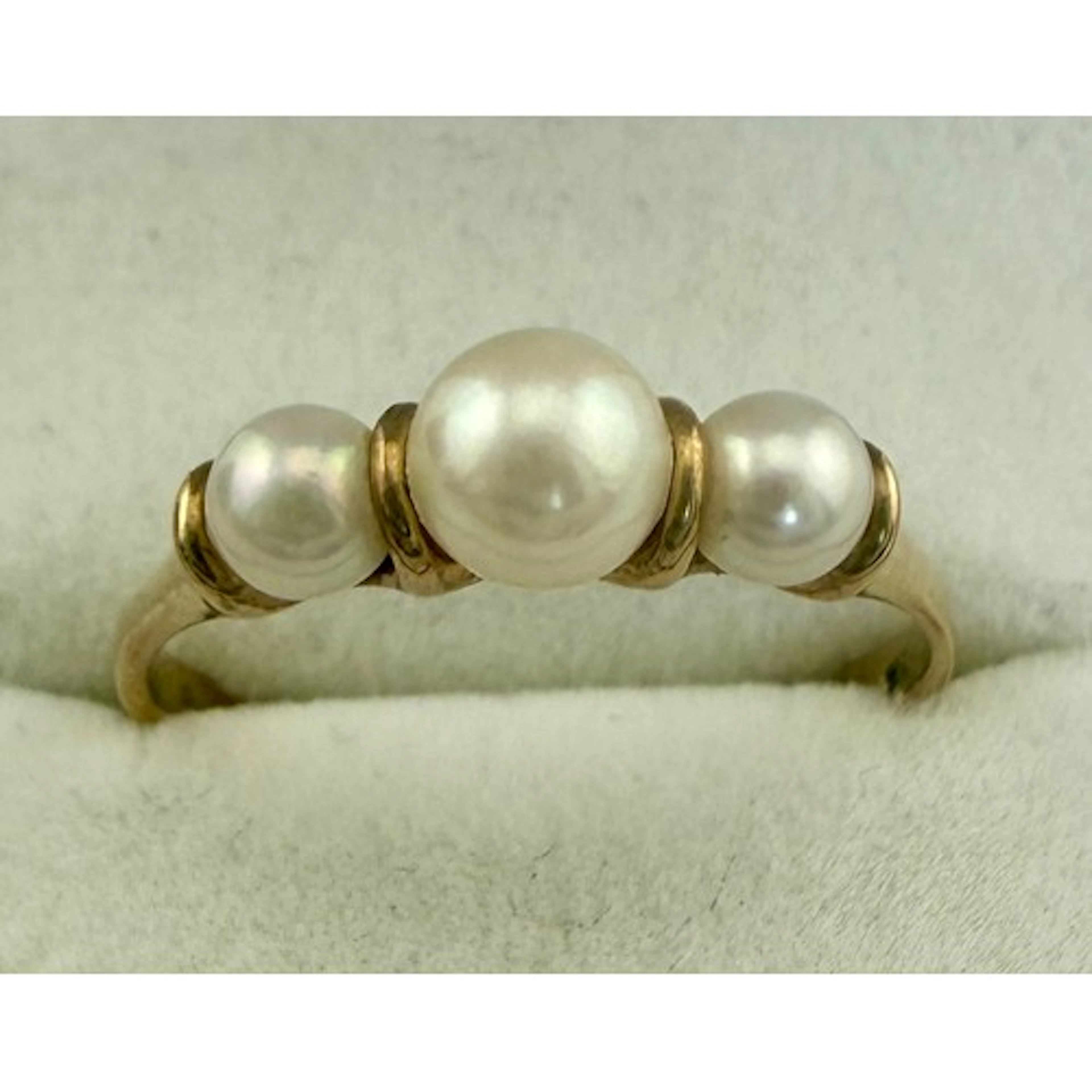 A 9 carat gold ring set with cultured pearls. Size R. Weight...