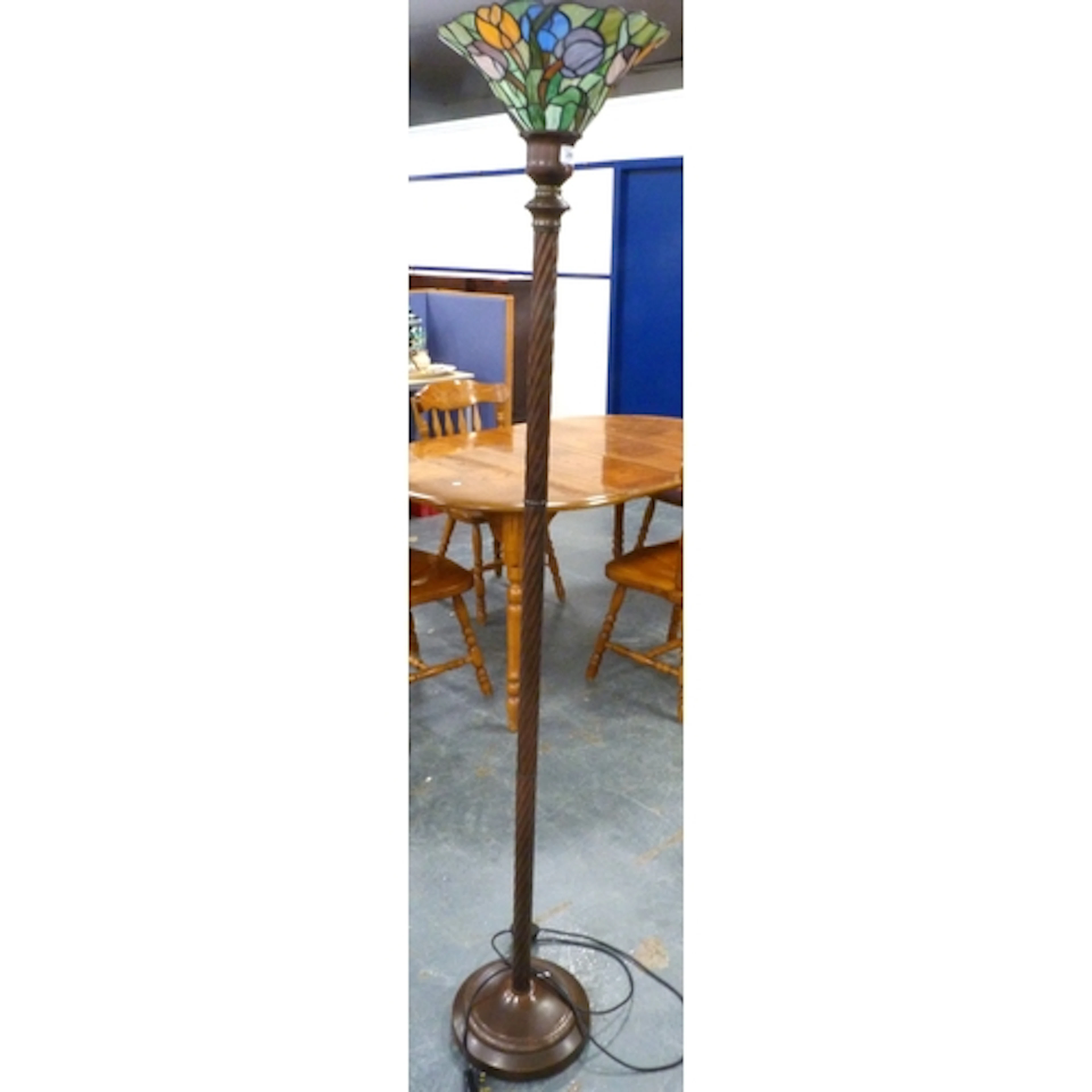 Metal standard lamp with a tiffany style shade.