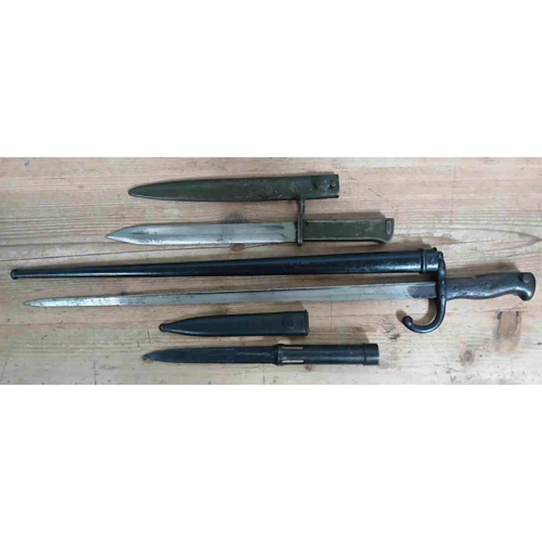 A group of three assorted bayonets and scabbards.