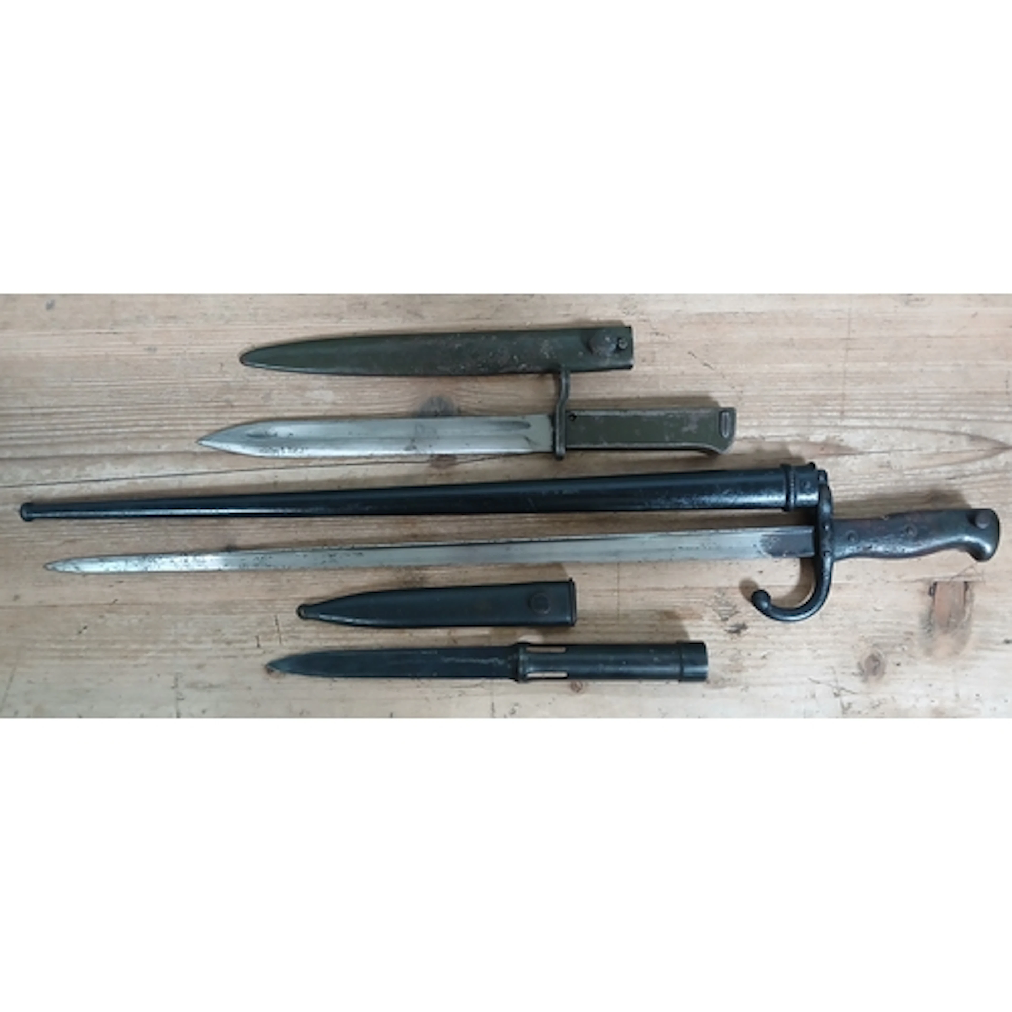 A group of three assorted bayonets and scabbards.