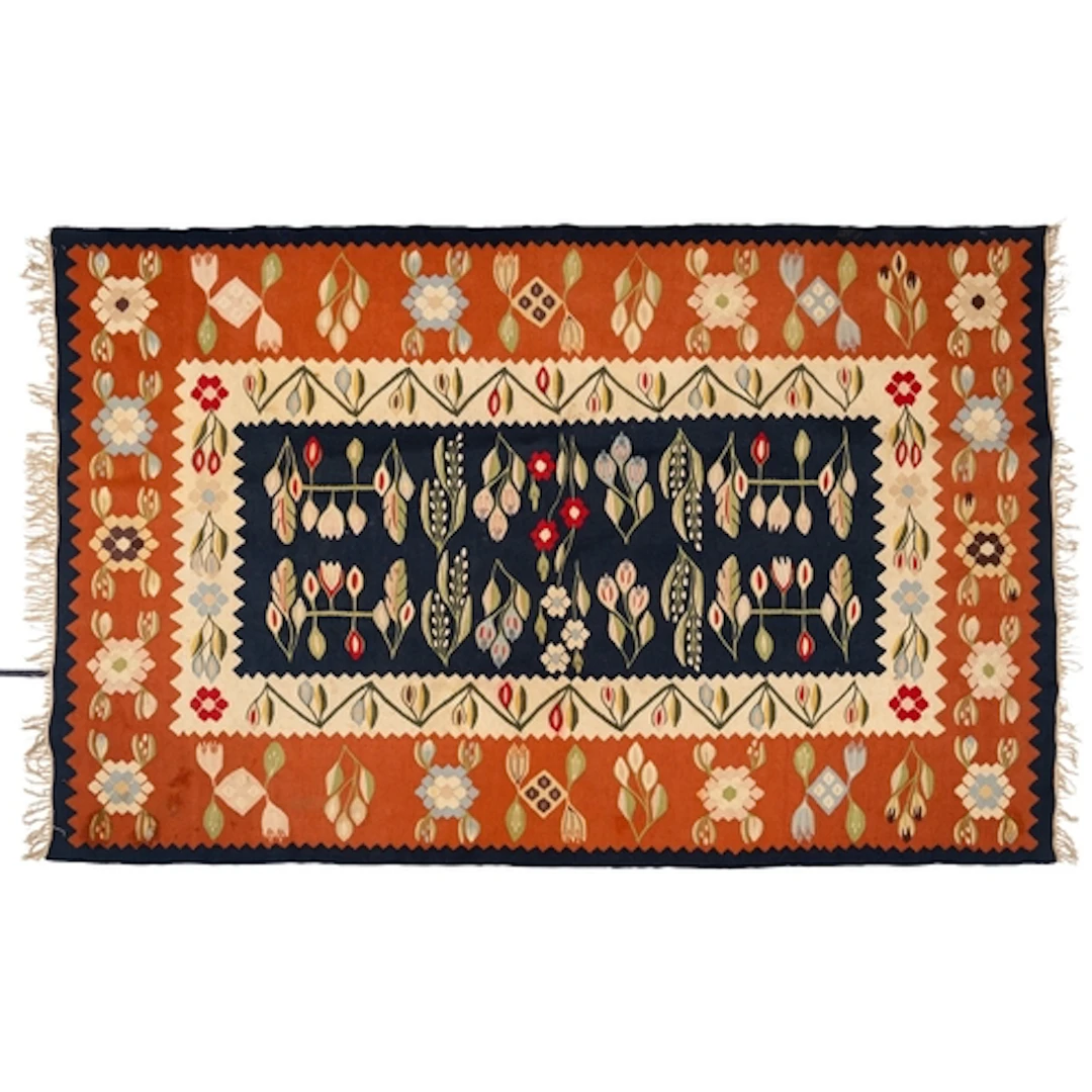 An Anatolian kelim, the indigo field with a design of flower...