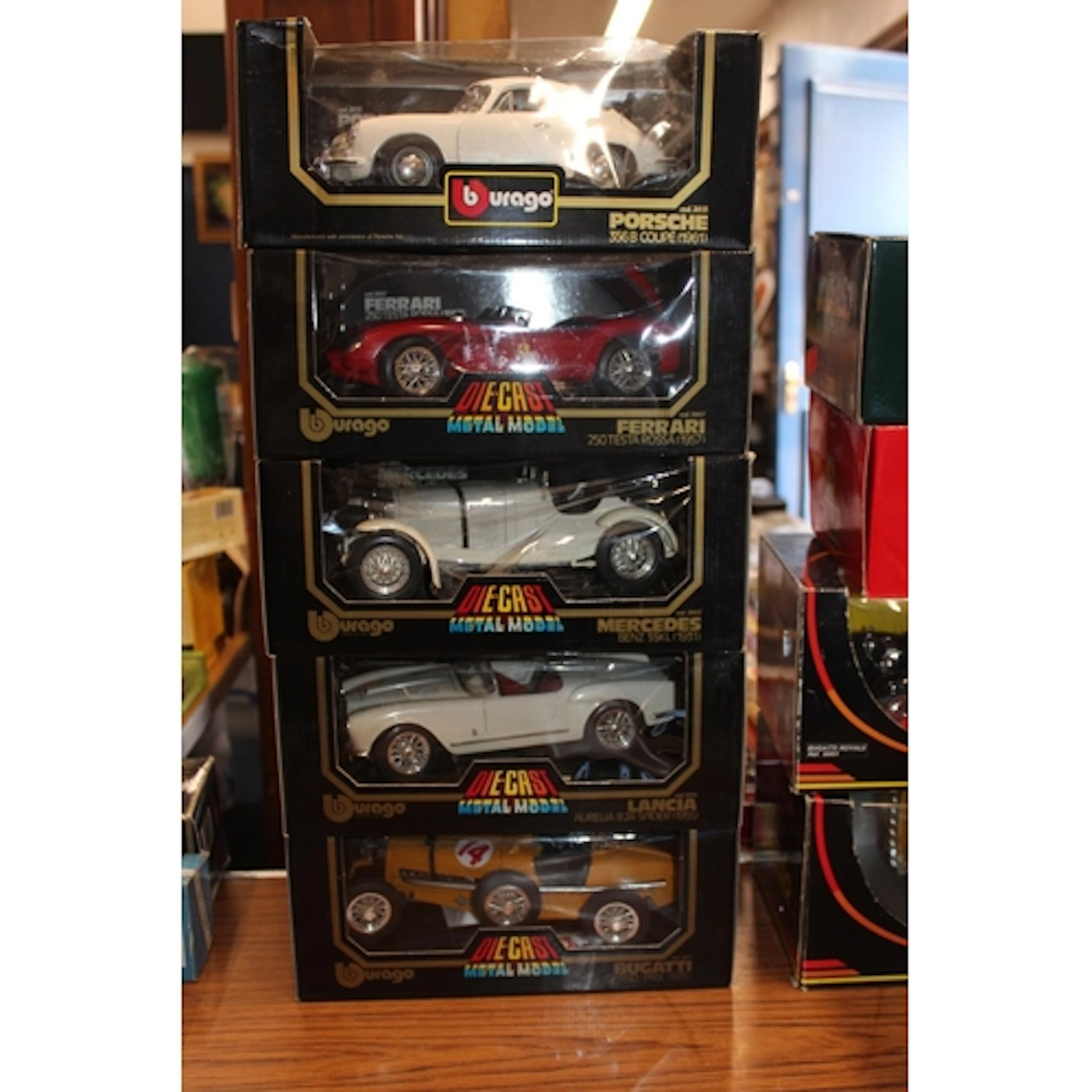 Five Burago 1:18 scale diecast model vehicles to include 302...