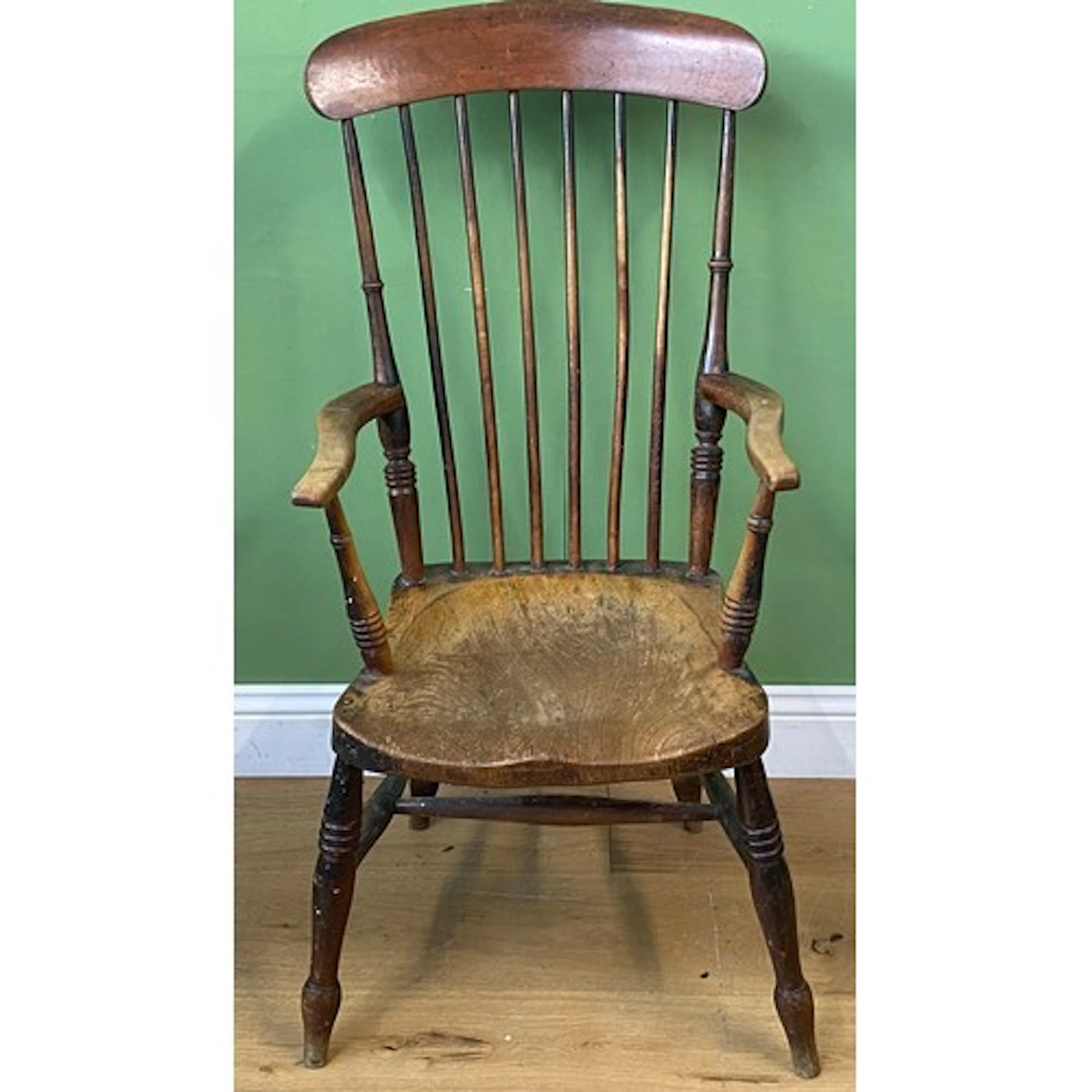 A stick back Windsor armchair, on turned legs and H stretche...