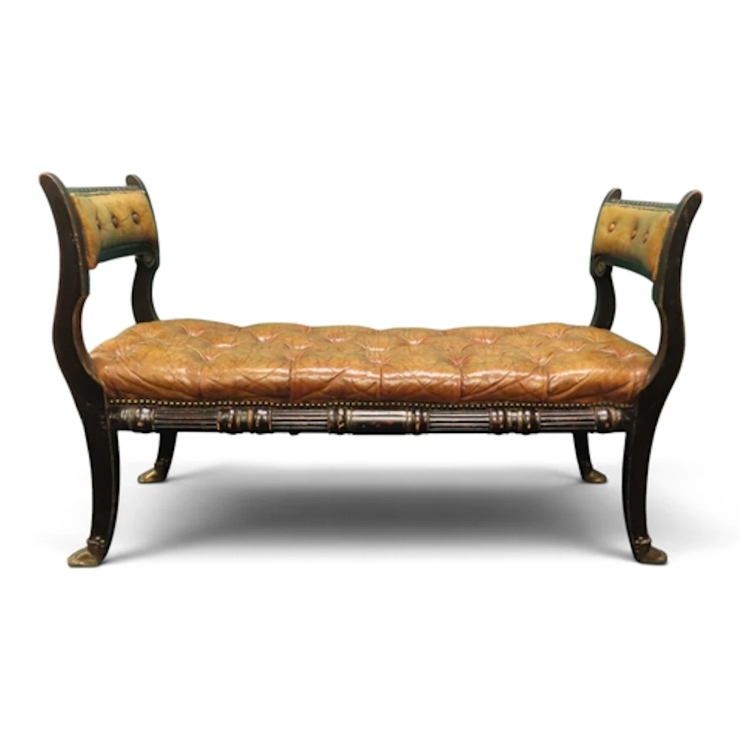 A 20th century Regency style brown leather button upholstere...