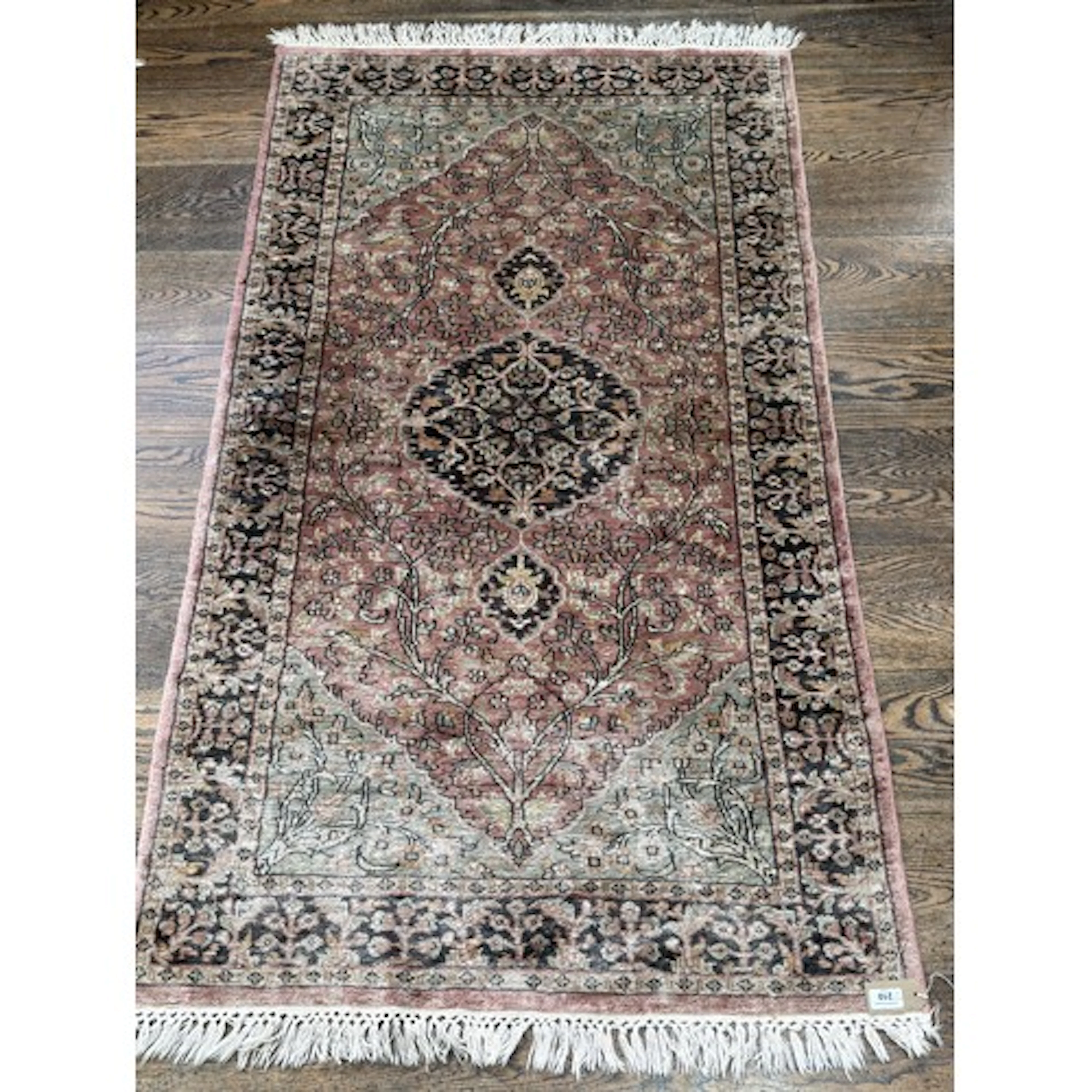 Tribal Rugs; an Indian Silk Kashmir rug, buff ground, with g...
