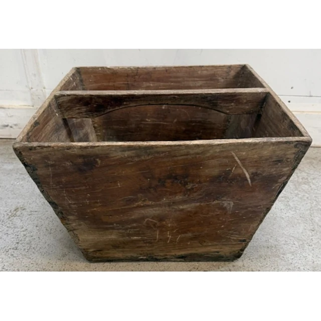 A pine log basket with central handle