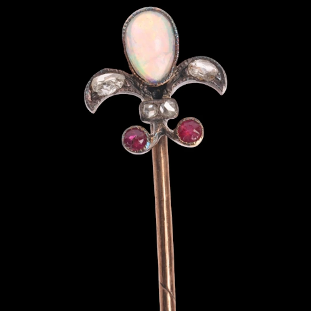 An Antique Victorian opal ruby and diamond fleur-de-lis stic...