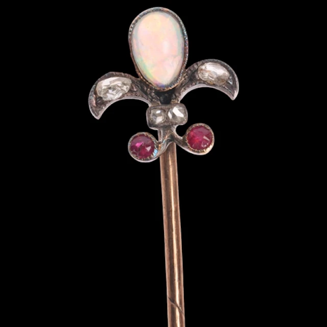 An Antique Victorian opal ruby and diamond fleur-de-lis stic...