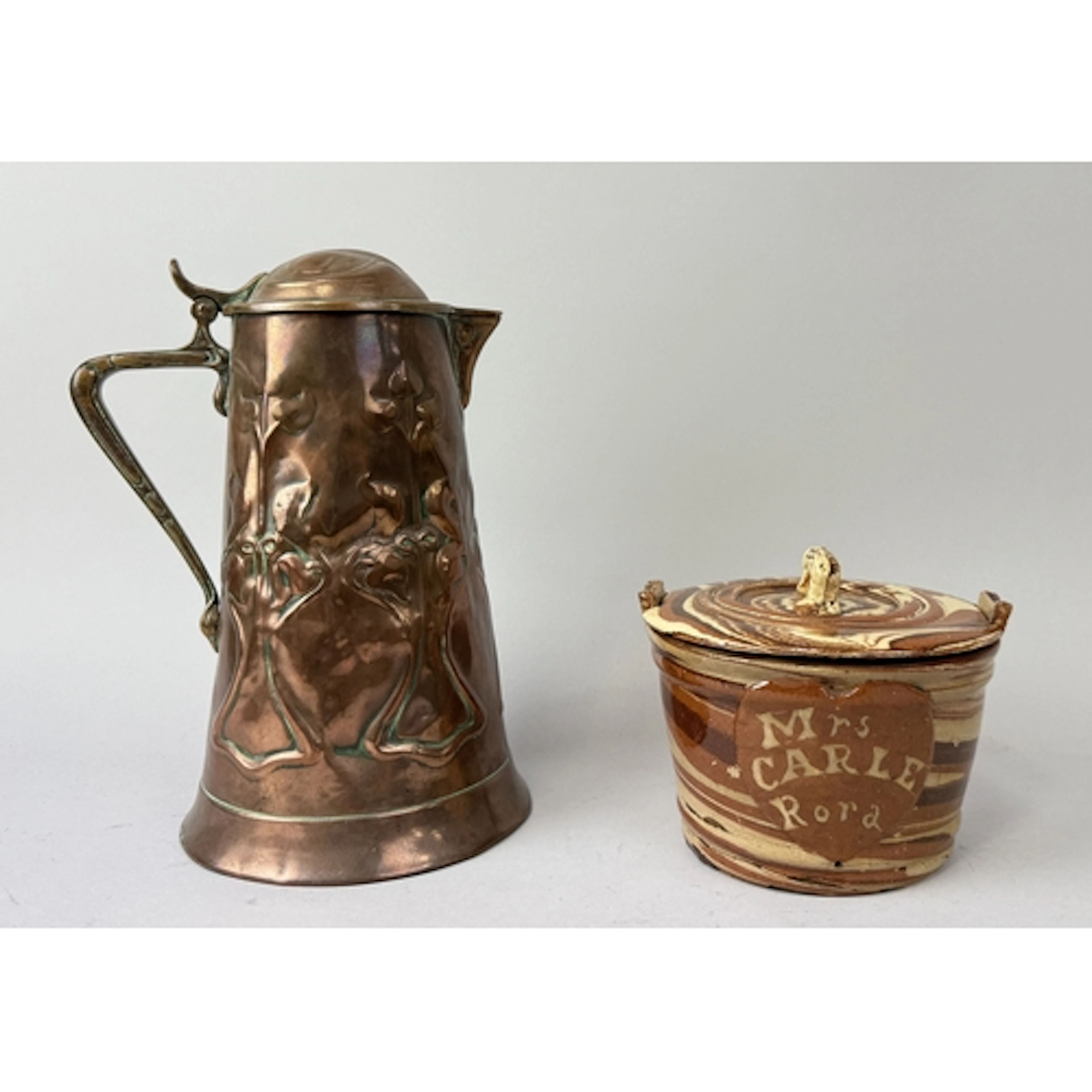 A COPPER ARTS AND CRAFTS JUG ALONG WITH A GLAZED CERAMIC POT...