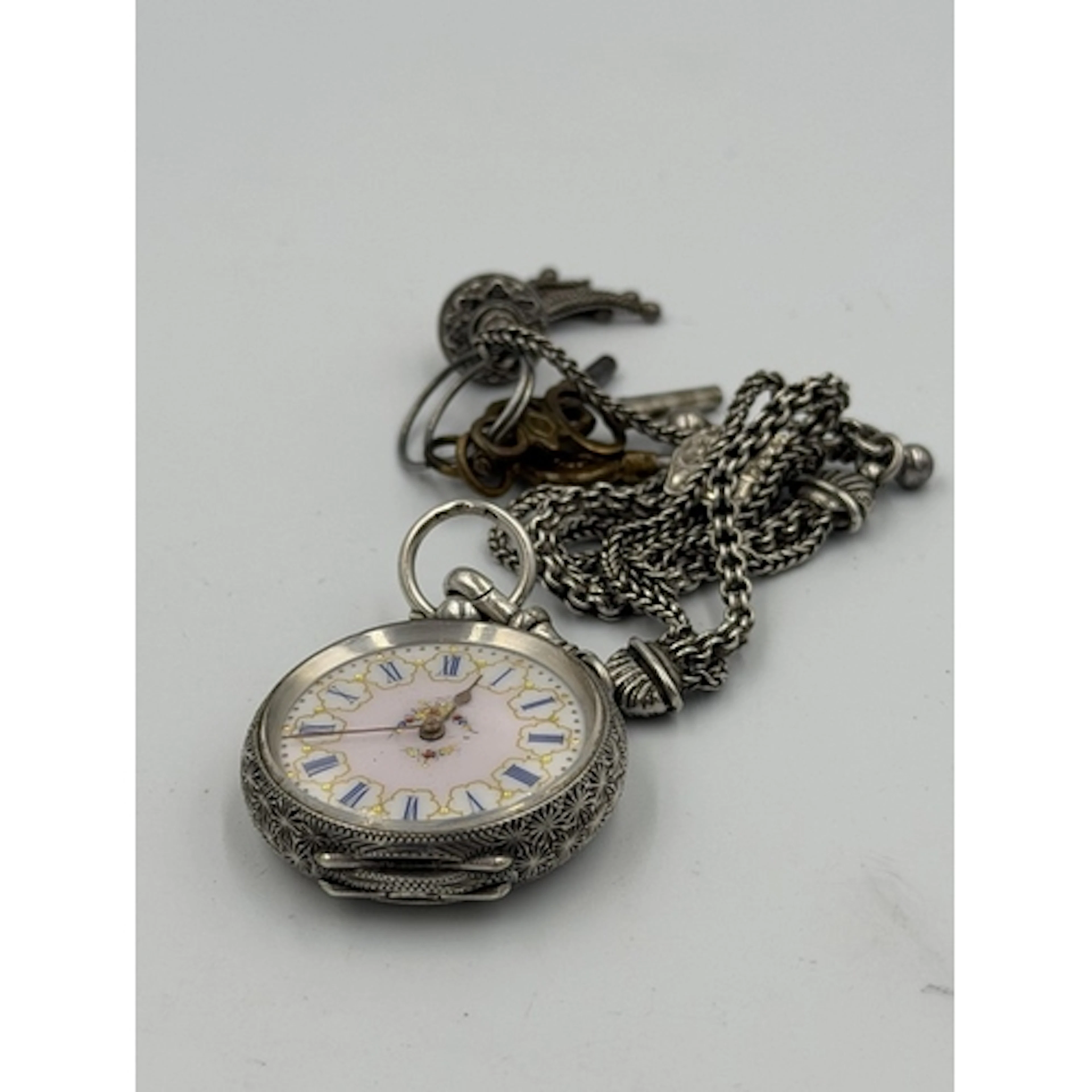 A Continental ladies pocket watch with floral pink enamel fa...