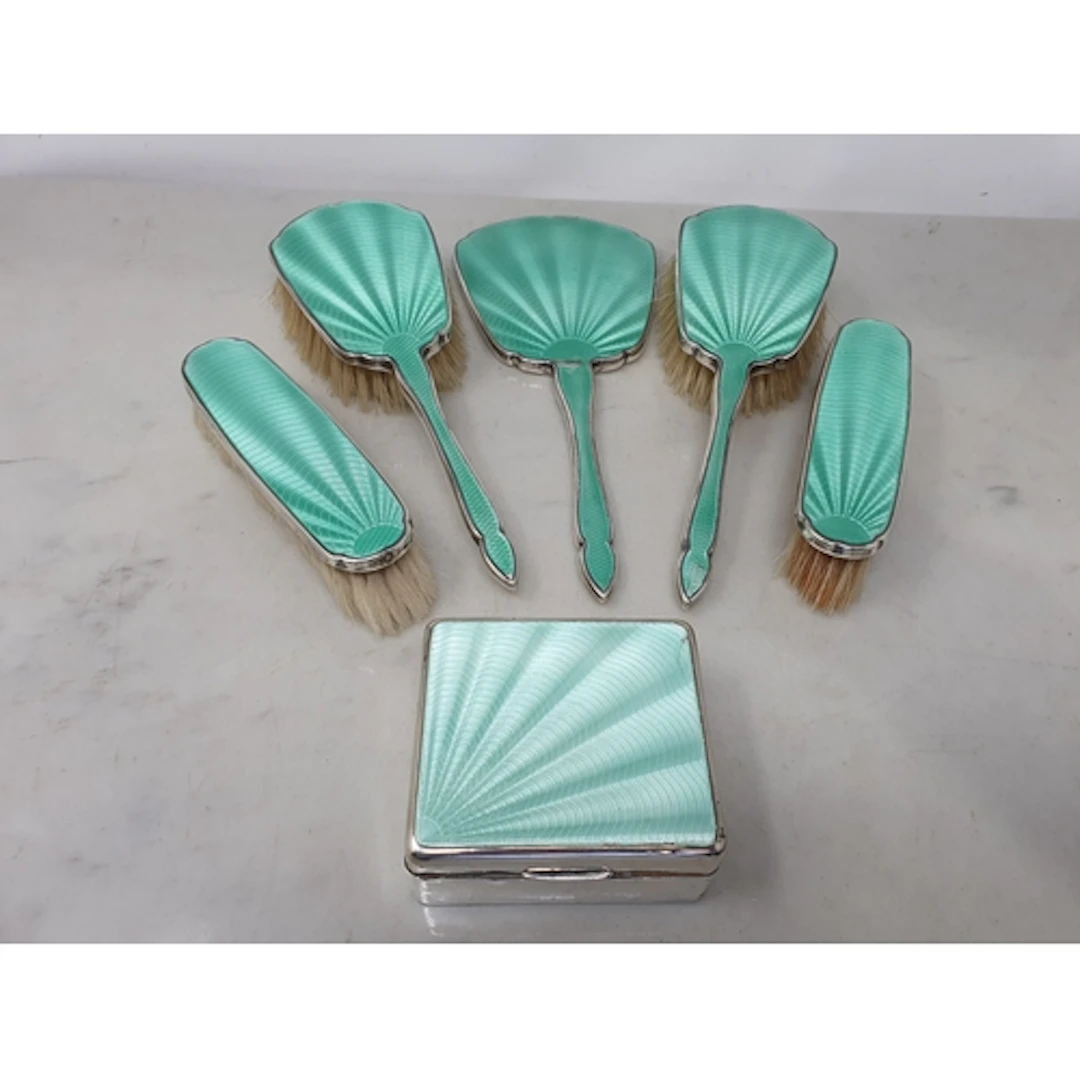 A George V silver mounted and green enamel Dressing Table Se...