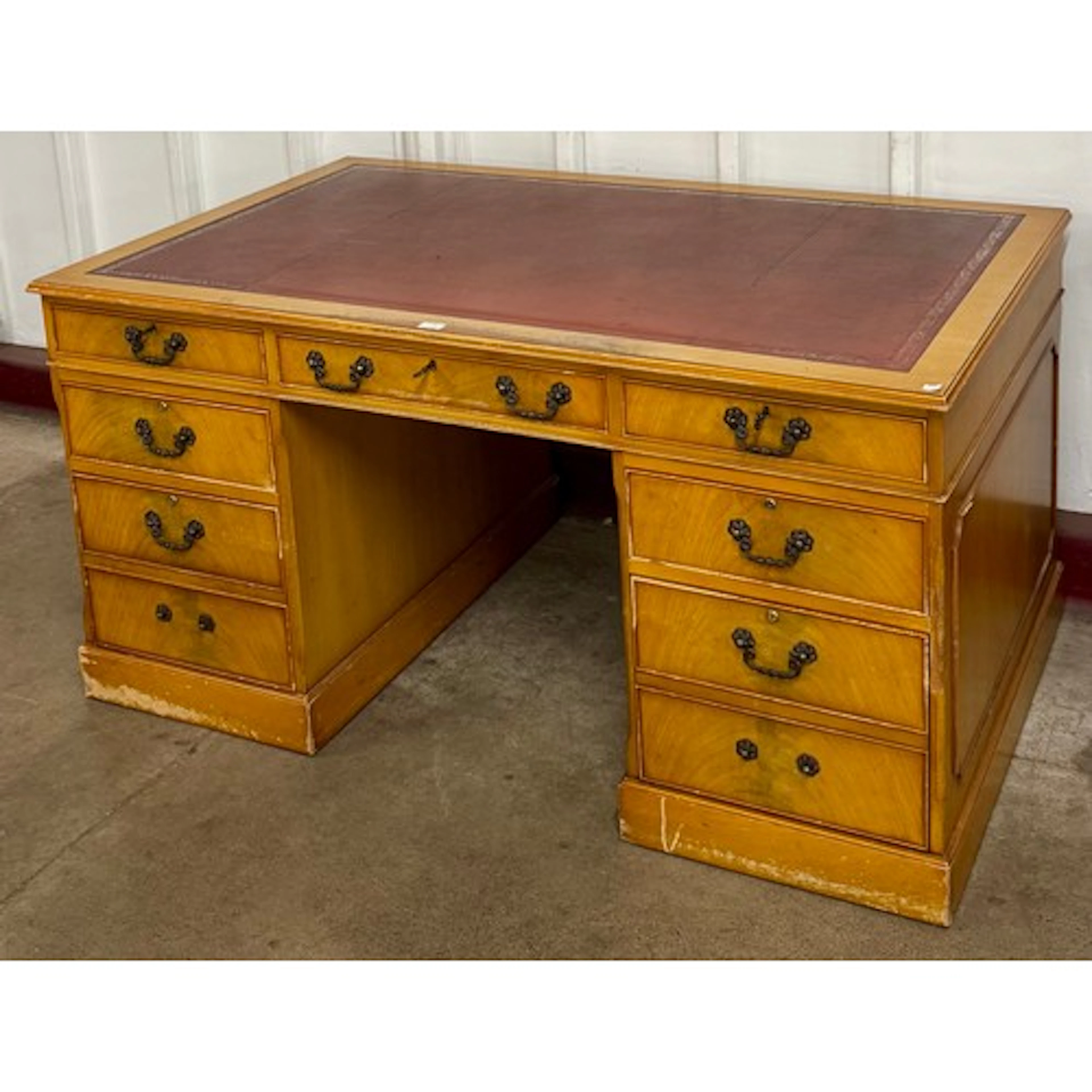 A Regency style yew wood and red leather topped partners des...