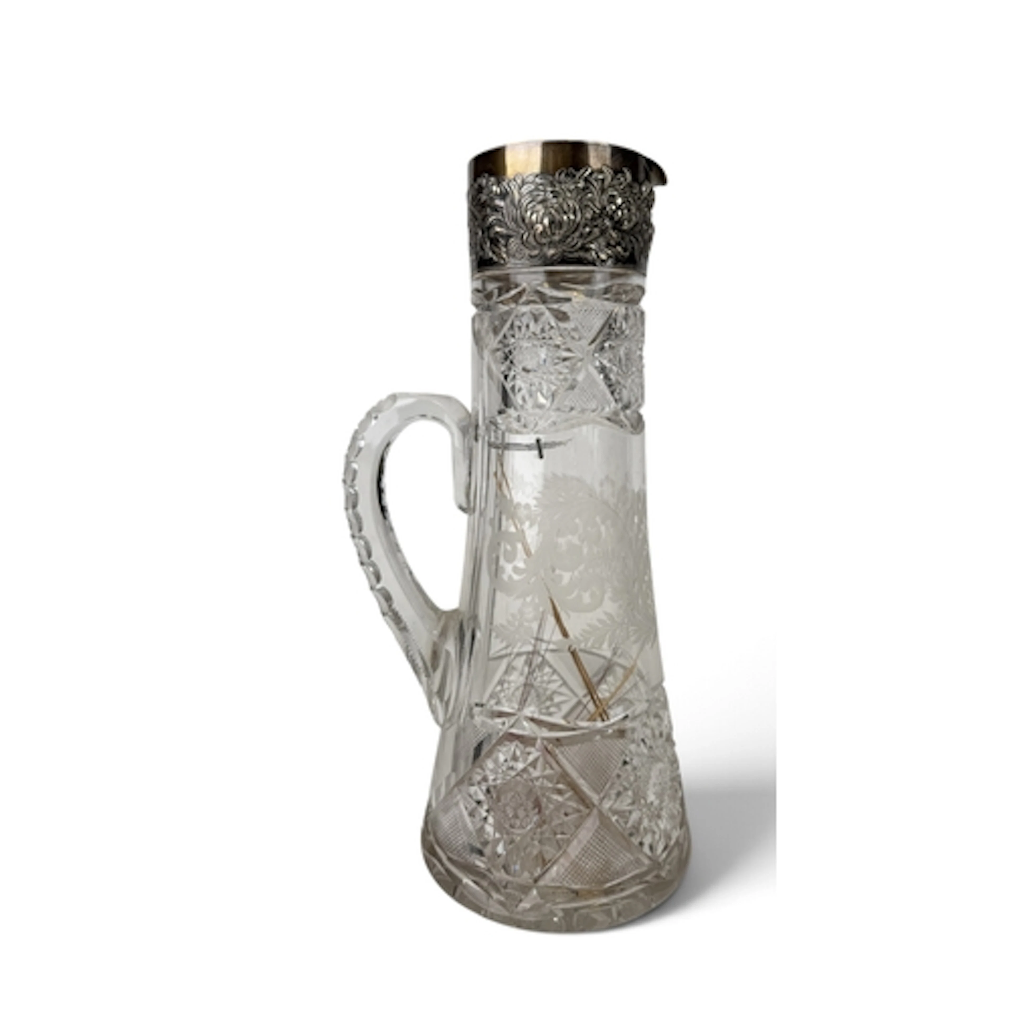 A LARGE CUT GLASS JUG, STERLING SILVER MOUNTED RIM AND SPOUT...