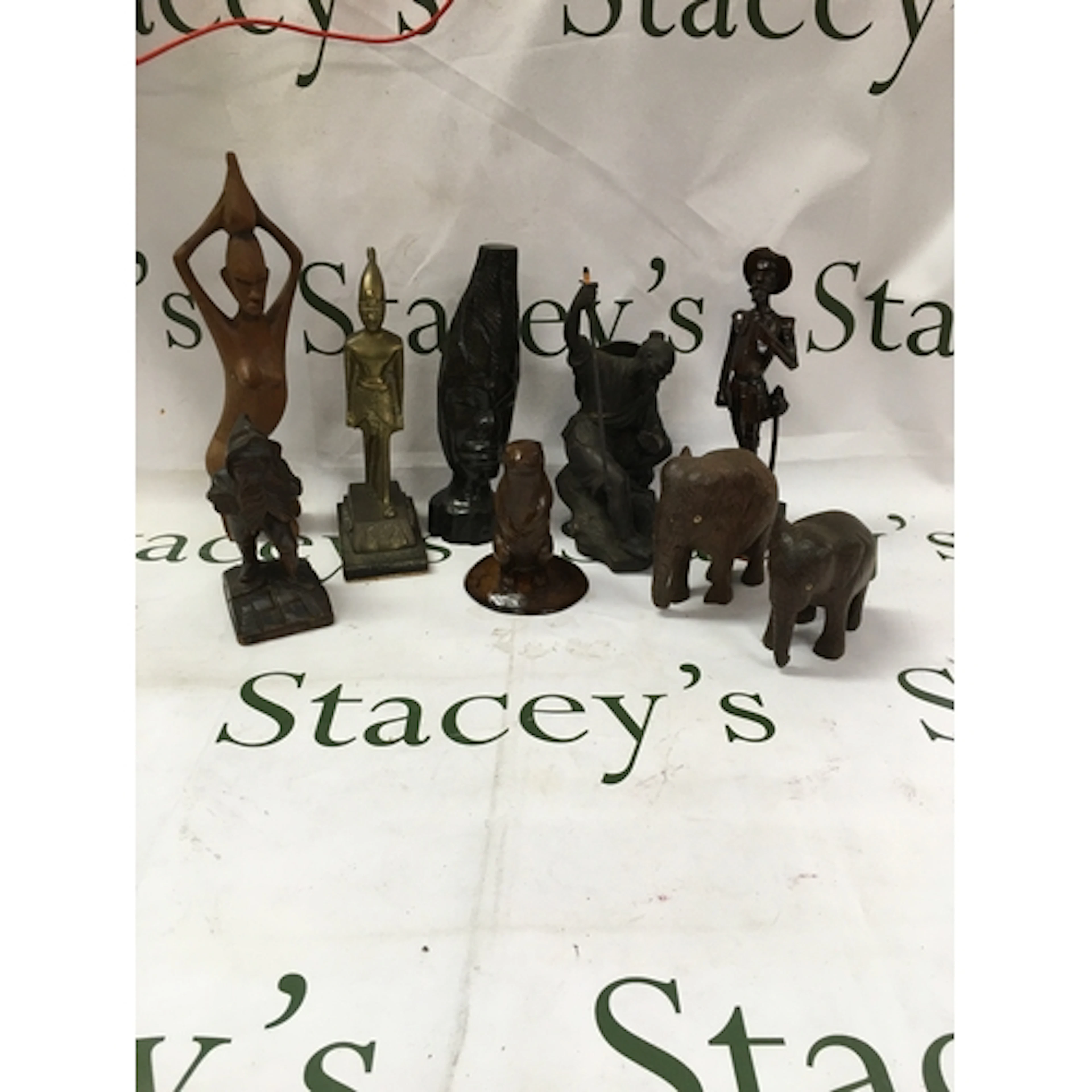 A collection of hand crafted African tribal art figures. Inc...