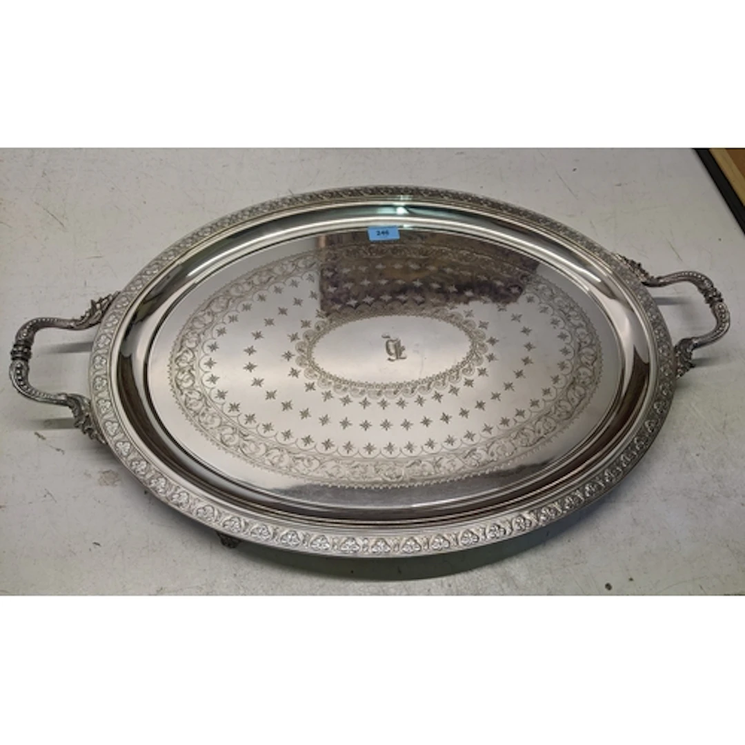 A silver plated oval tray, with twin cast carrying handles, ...