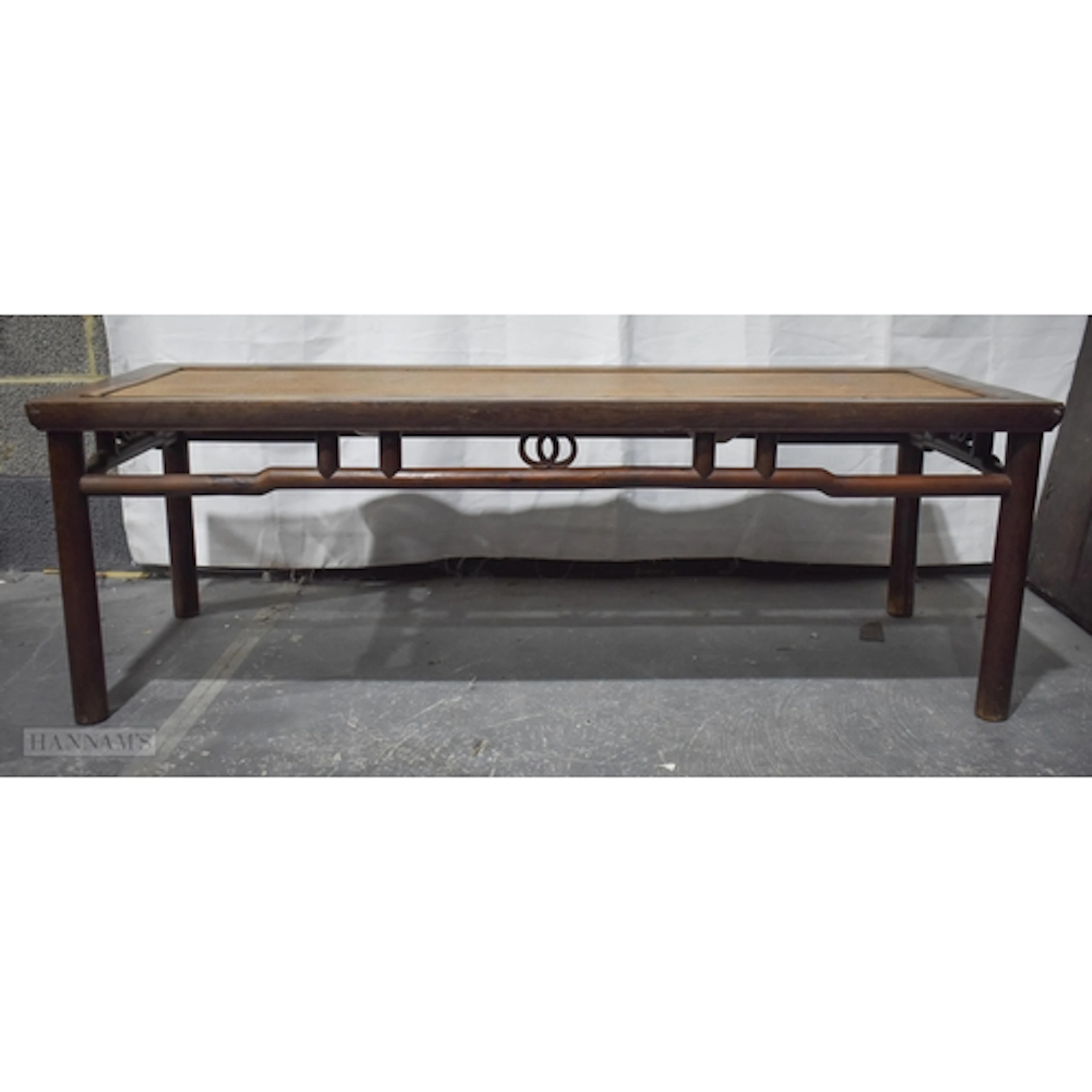 A CHINESE QING DYNASTY CARVED HARDWOOD LOW RECTANGULAR TABLE...