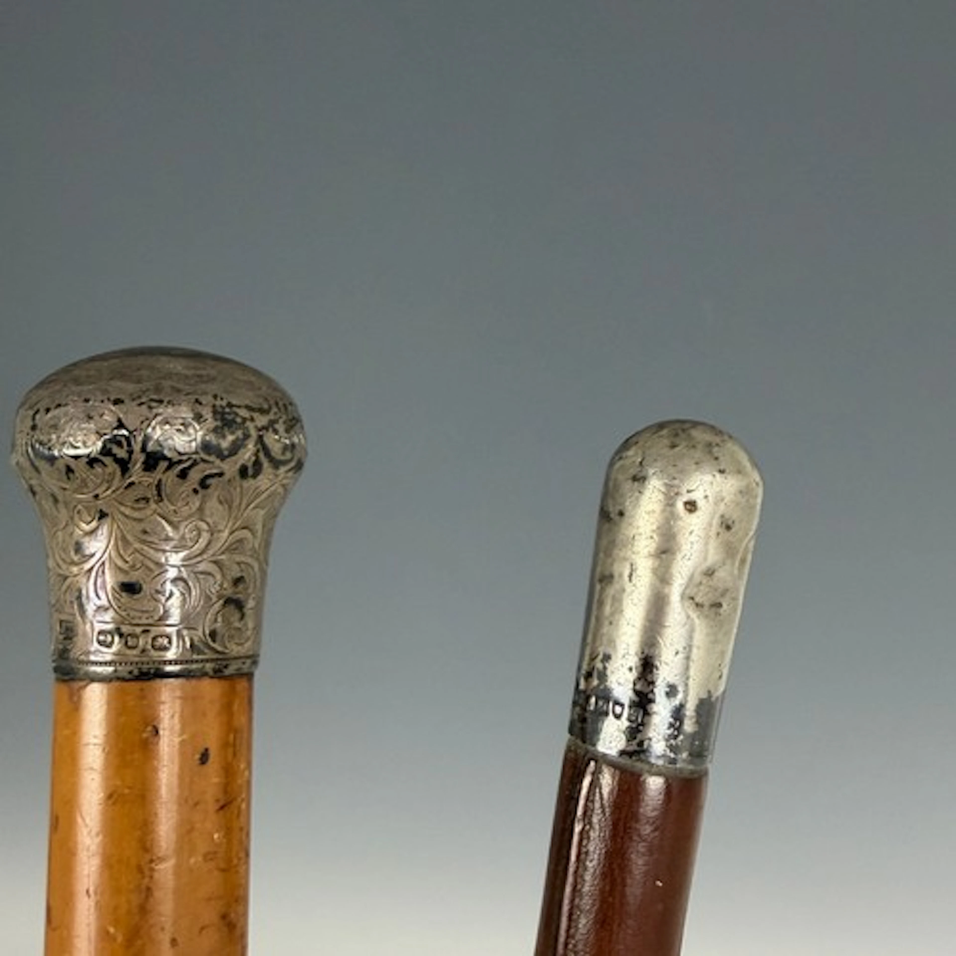 An antique silver-topped walking cane, and a silver-topped r...