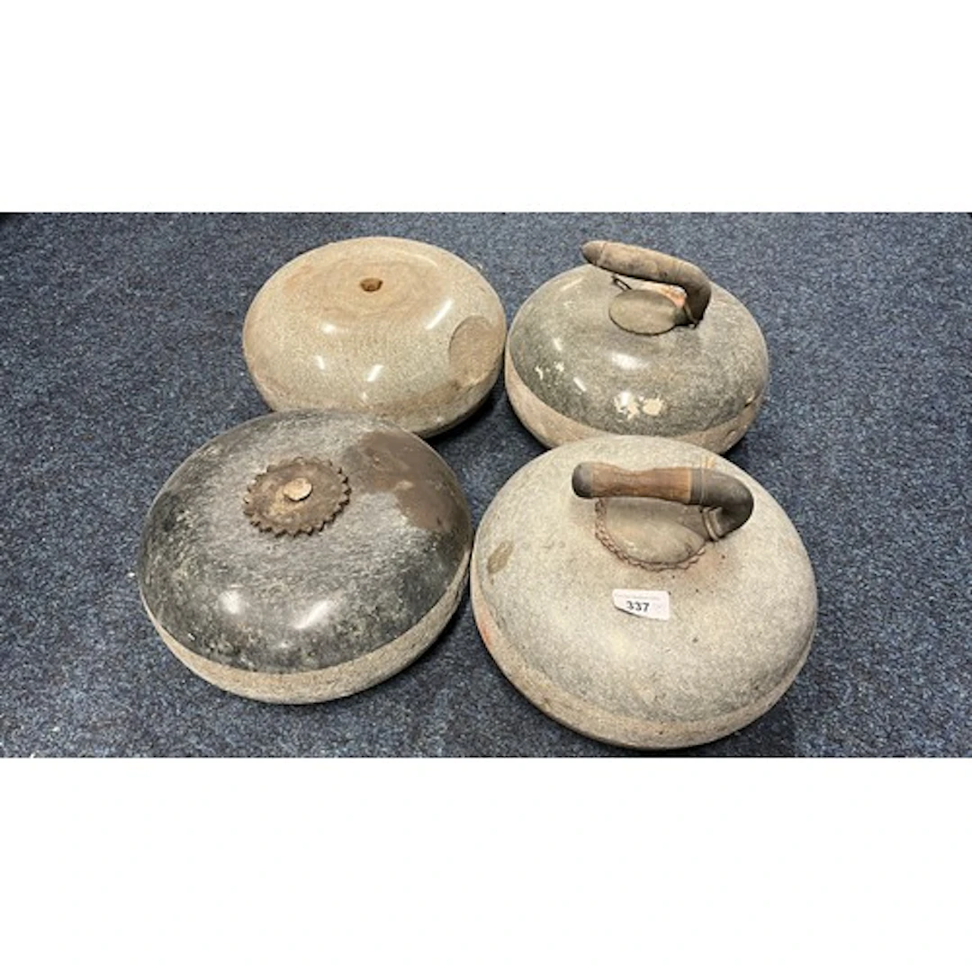 Group of four curling stones.