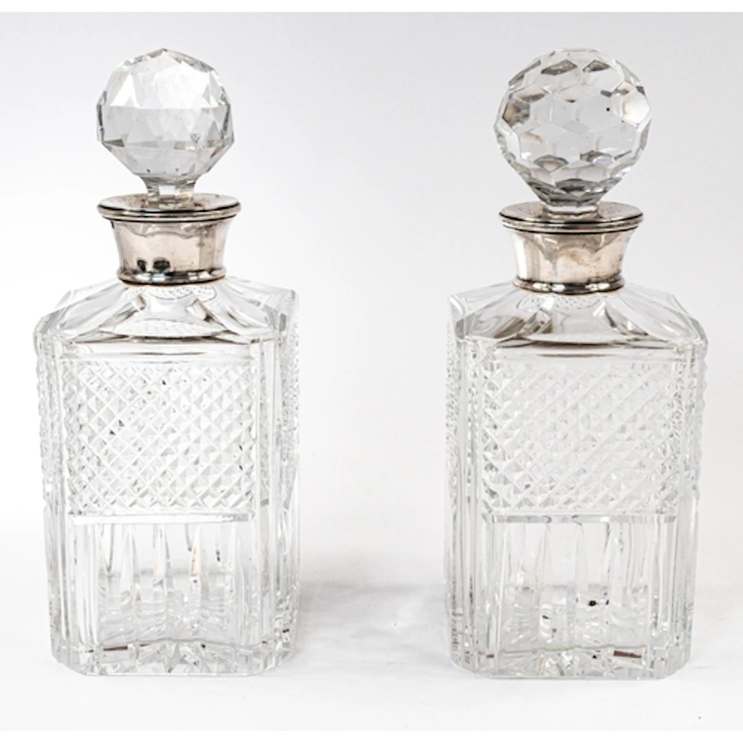 Glass A pair of silver-mounted cut glass decanters and stop...