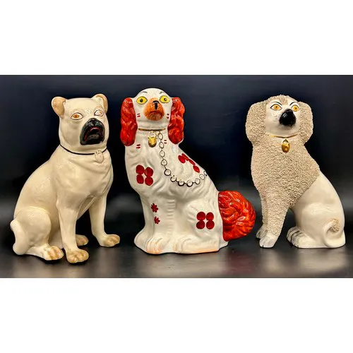 Two Staffordshire dogs, Poodle and Pug, together with a Span...